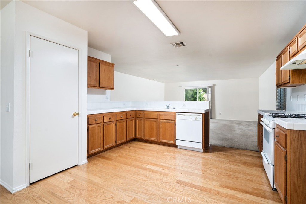 6361 Pintail Way Fontana, CA 92336 - Photo 8 of 32 a kitchen with a stove top oven sink and a refrigerator