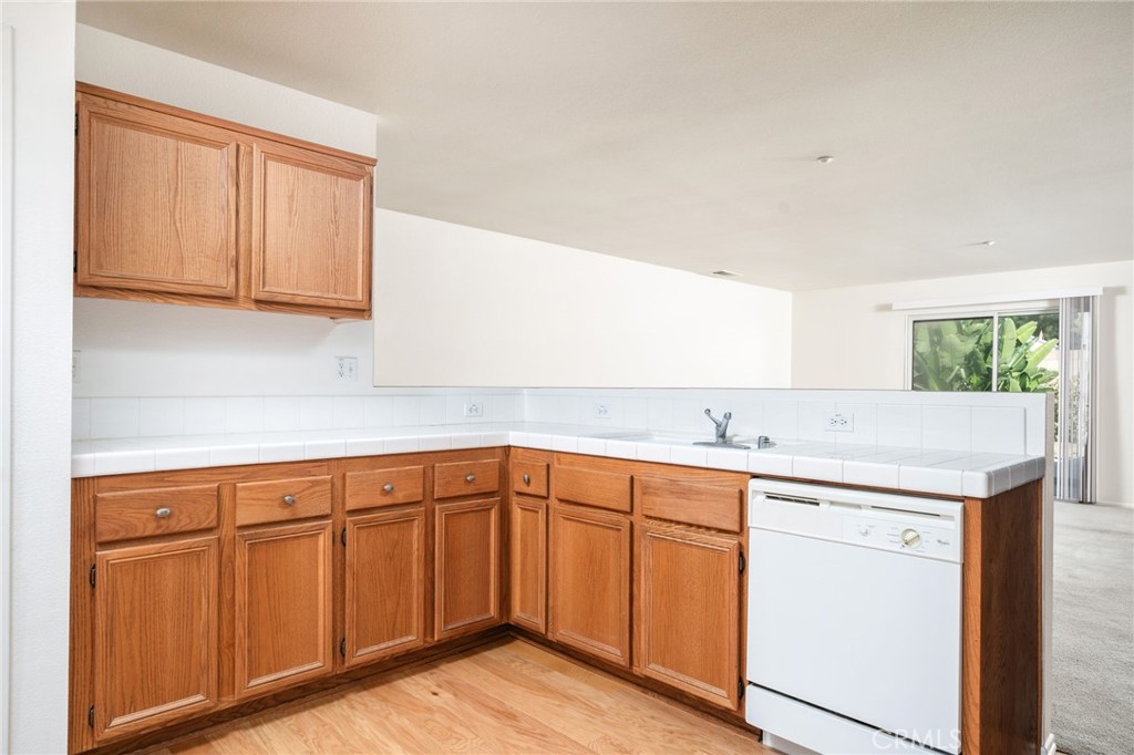 6361 Pintail Way Fontana, CA 92336 - Photo 9 of 32 a kitchen with a sink cabinets and wooden floor