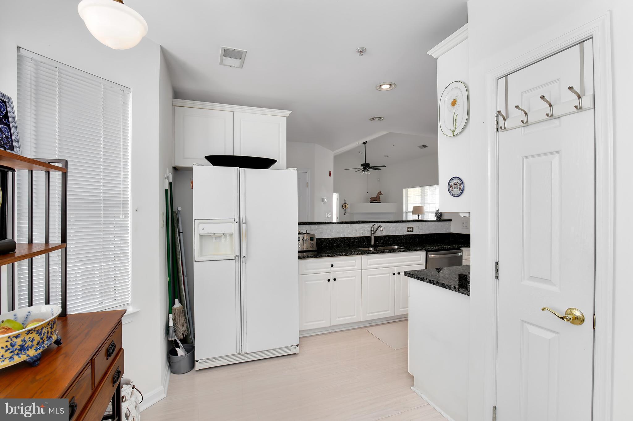 25272 Riffleford Square, Unit 304 Chantilly, VA 20152 - Photo 17 of 30 a kitchen with a refrigerator a stove top oven