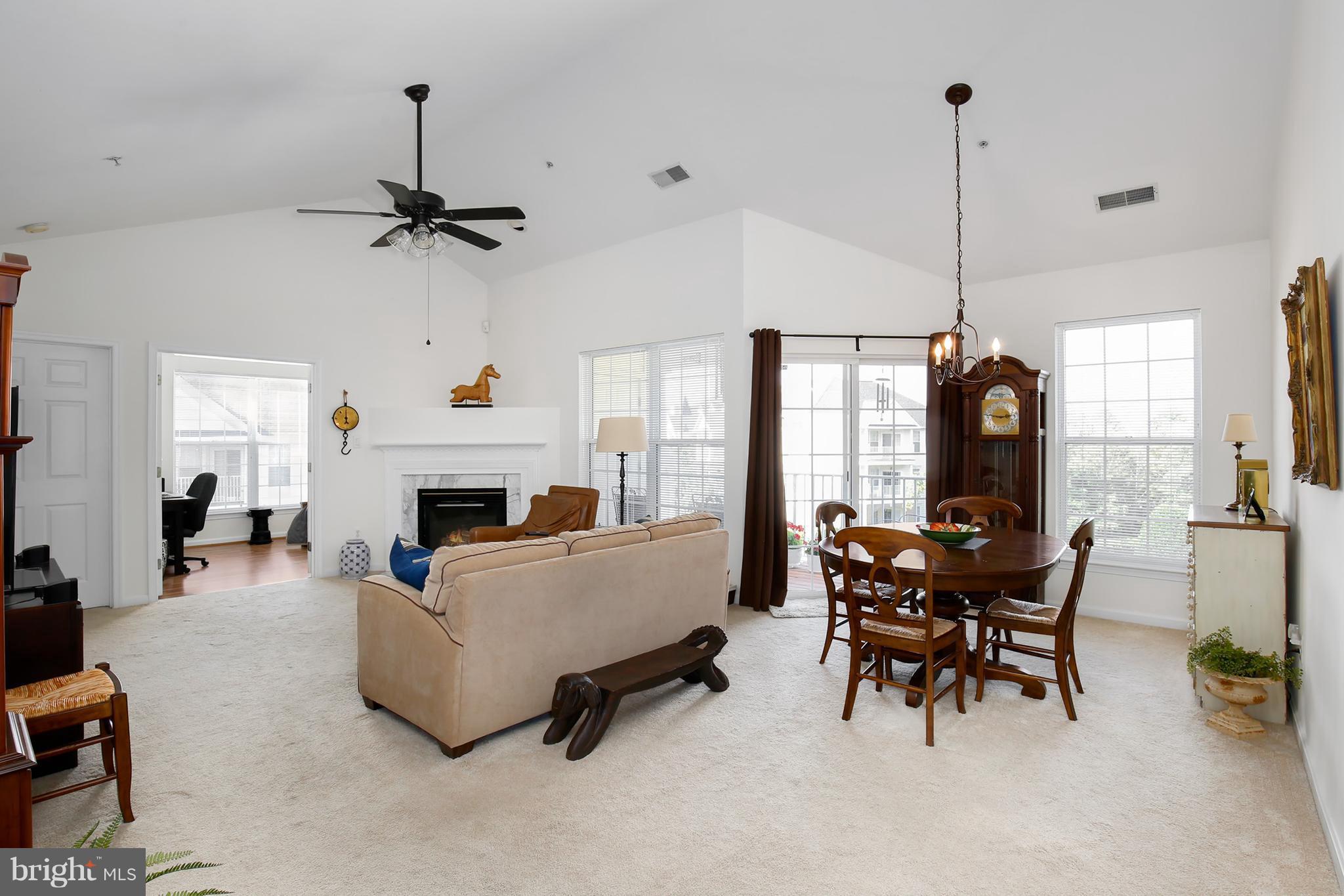 25272 Riffleford Square, Unit 304 Chantilly, VA 20152 - Photo 3 of 30 a living room with furniture and a fireplace