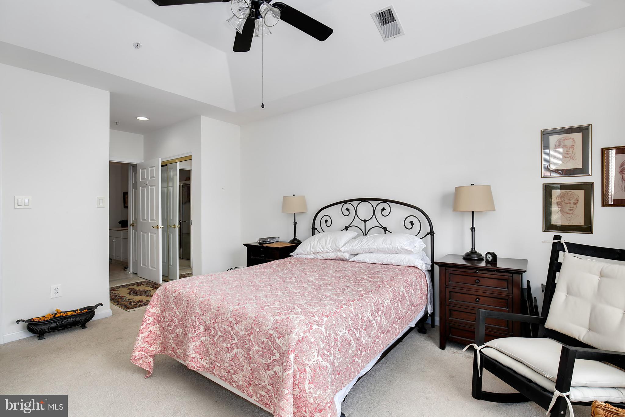 25272 Riffleford Square, Unit 304 Chantilly, VA 20152 - Photo 21 of 30 a bedroom with a bed a dresser and chair
