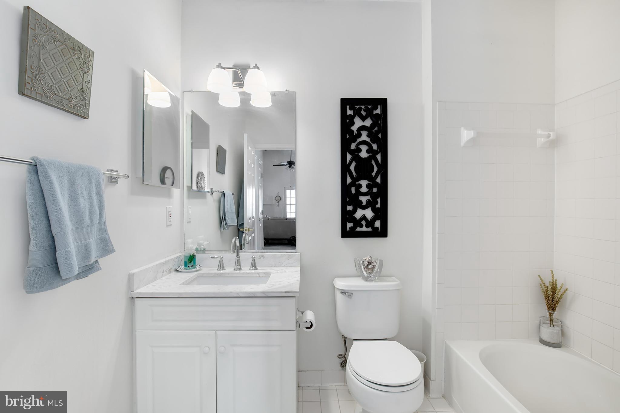 25272 Riffleford Square, Unit 304 Chantilly, VA 20152 - Photo 26 of 30 a bathroom with a sink a toilet and mirror