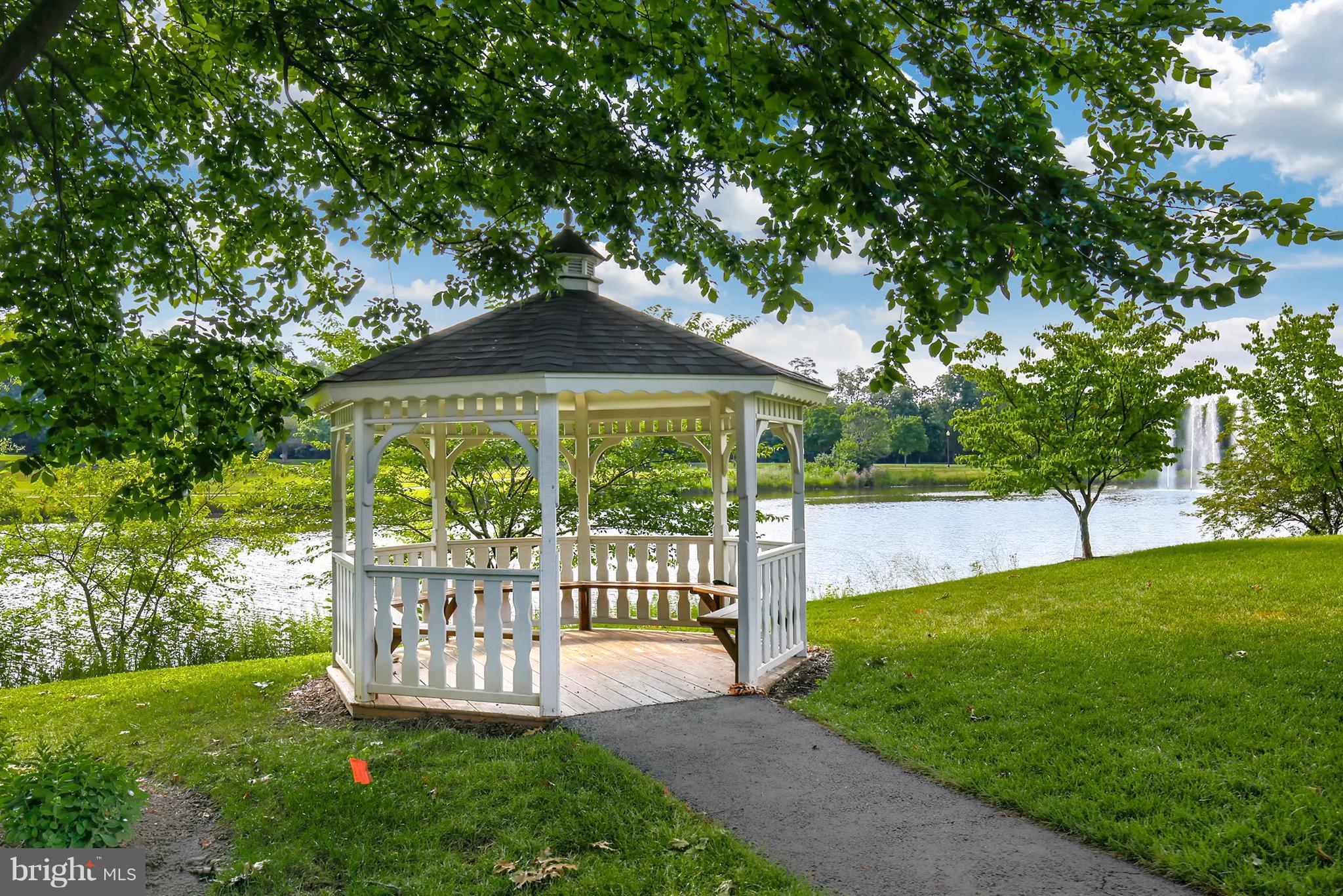 25272 Riffleford Square, Unit 304 Chantilly, VA 20152 - Photo 30 of 30 a view of a garden with a bench in a garden