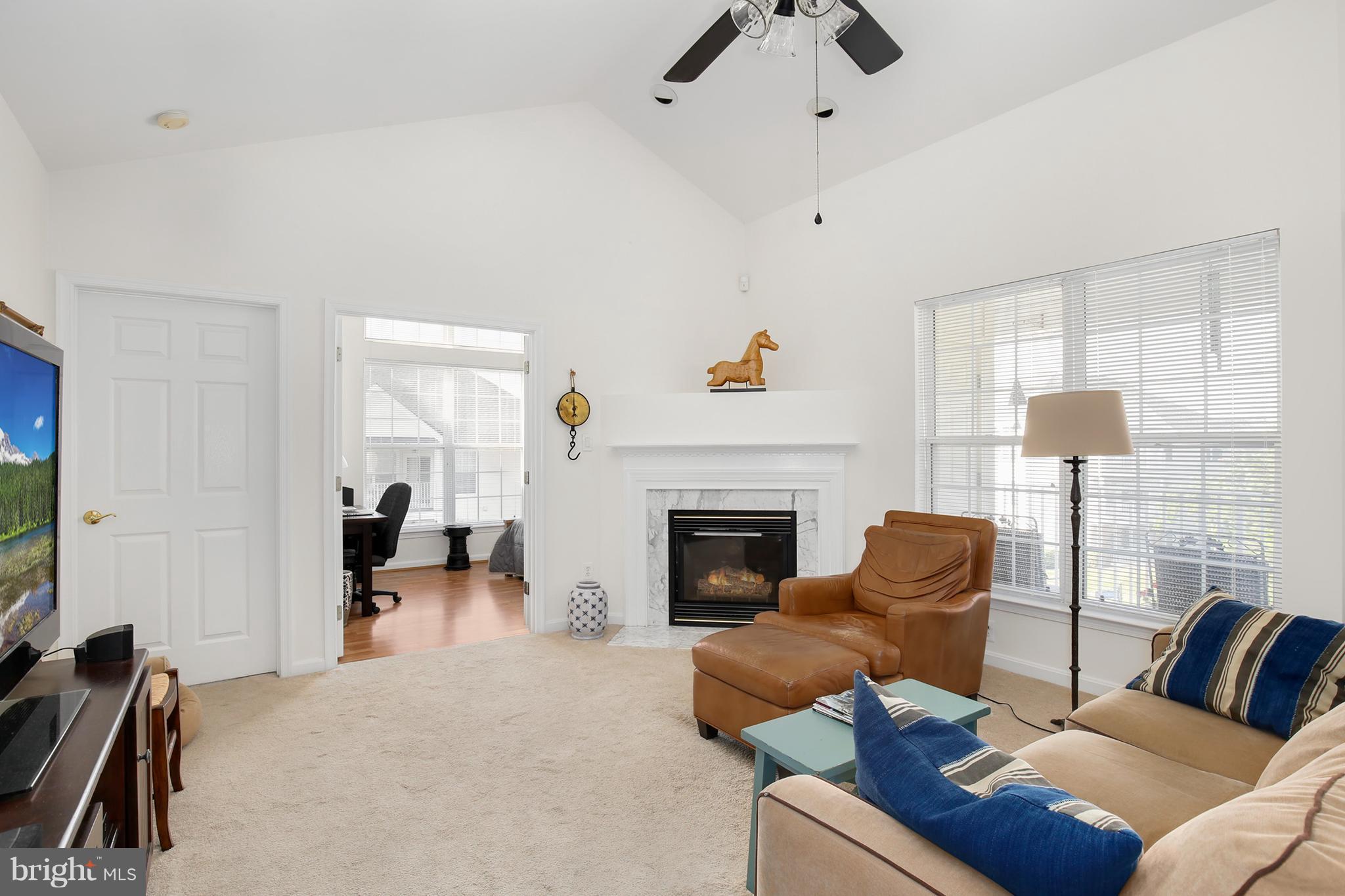 25272 Riffleford Square, Unit 304 Chantilly, VA 20152 - Photo 4 of 30 a living room with furniture or couch and a flat screen tv