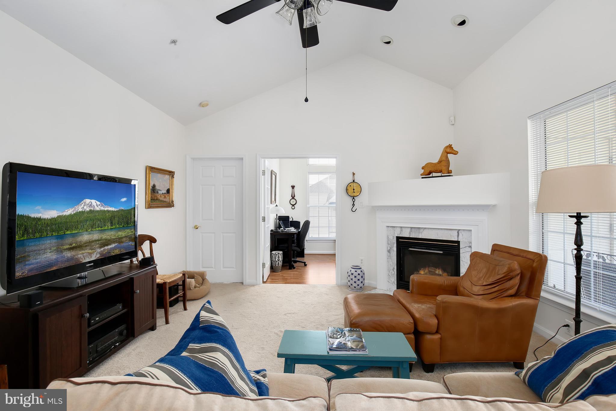 25272 Riffleford Square, Unit 304 Chantilly, VA 20152 - Photo 5 of 30 a living room with furniture and a flat screen tv