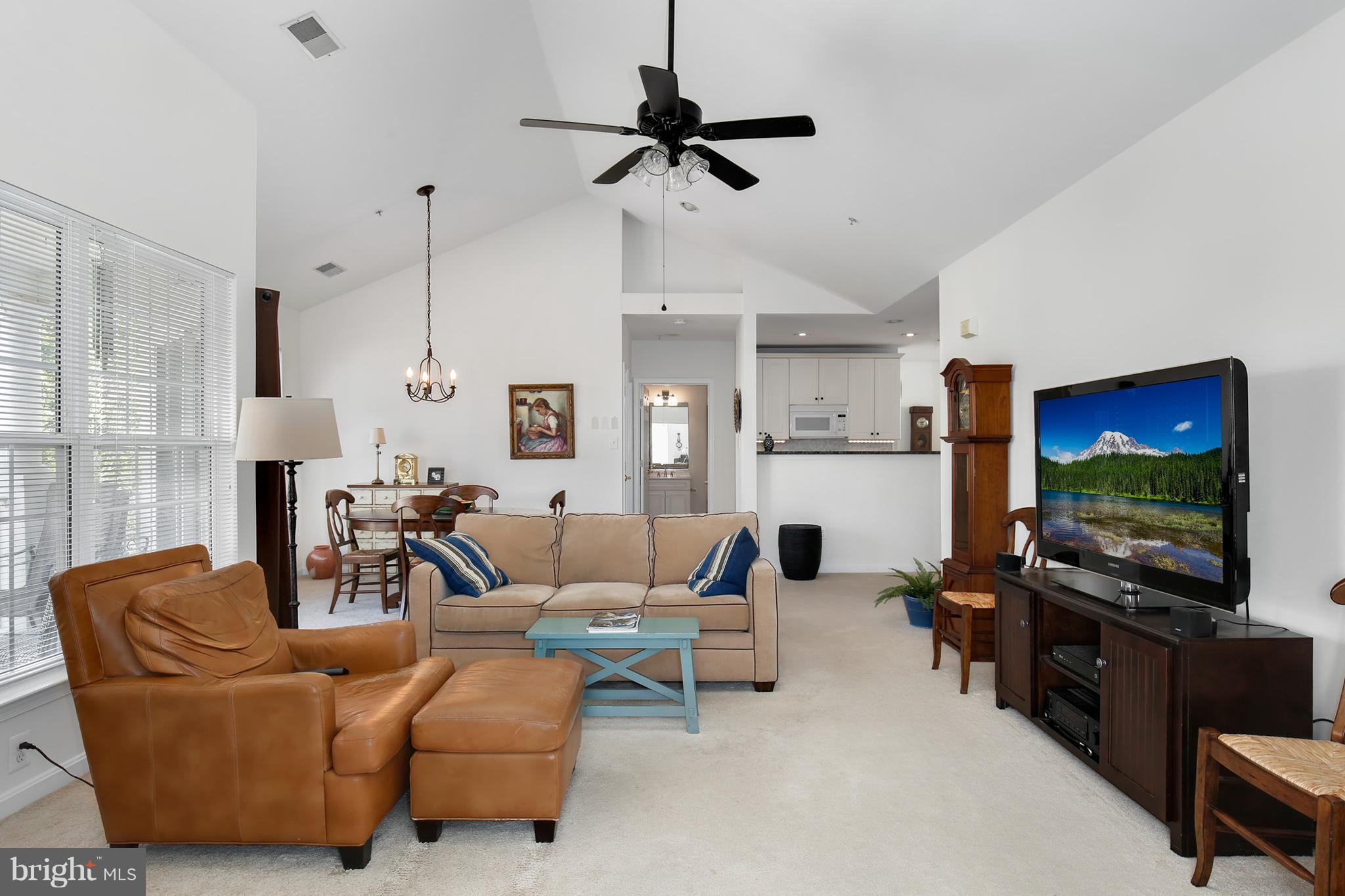 25272 Riffleford Square, Unit 304 Chantilly, VA 20152 - Photo 6 of 30 a living room with furniture and a flat screen tv