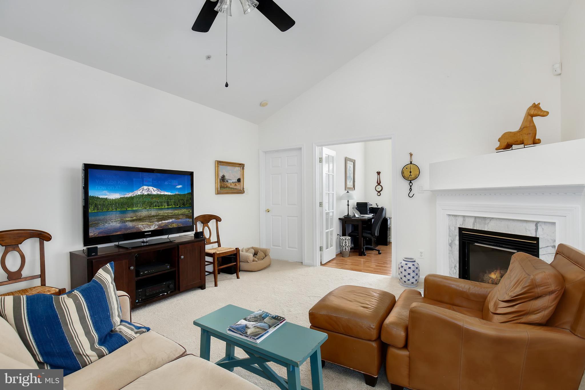 25272 Riffleford Square, Unit 304 Chantilly, VA 20152 - Photo 8 of 30 a living room with furniture and a flat screen tv