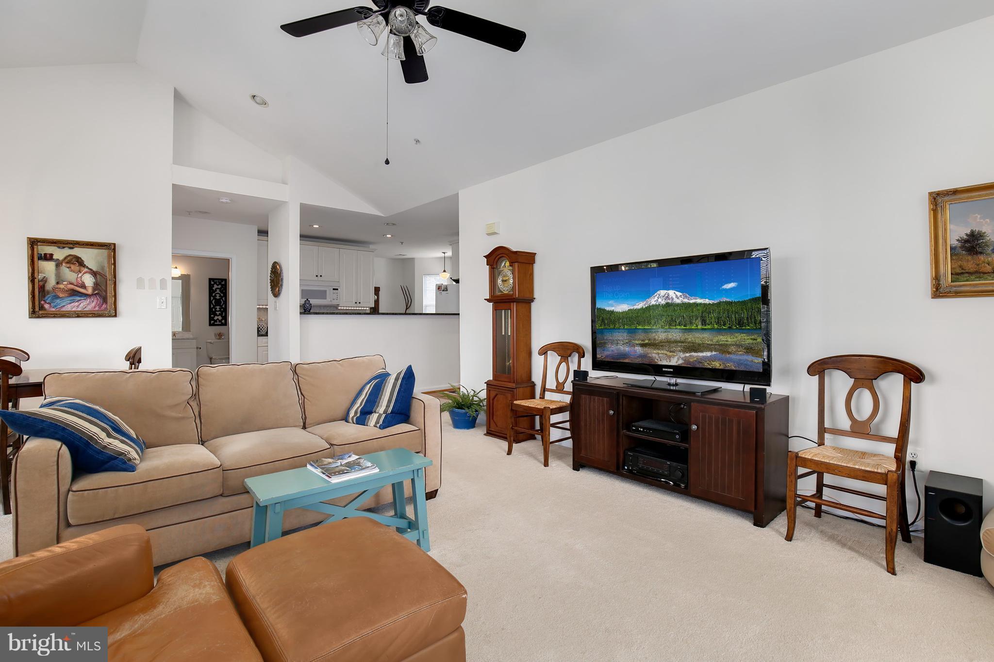 25272 Riffleford Square, Unit 304 Chantilly, VA 20152 - Photo 9 of 30 a living room with furniture and a flat screen tv