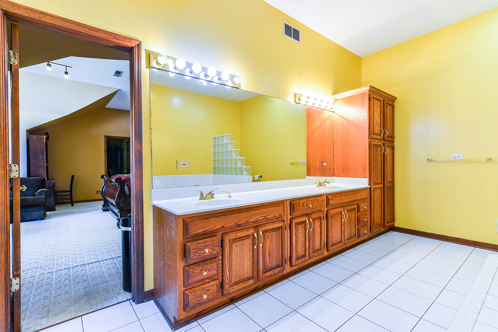 624 Riedy Road Lisle, IL 60532 - Photo 33 of 68 a bathroom with a double vanity sink and a mirror