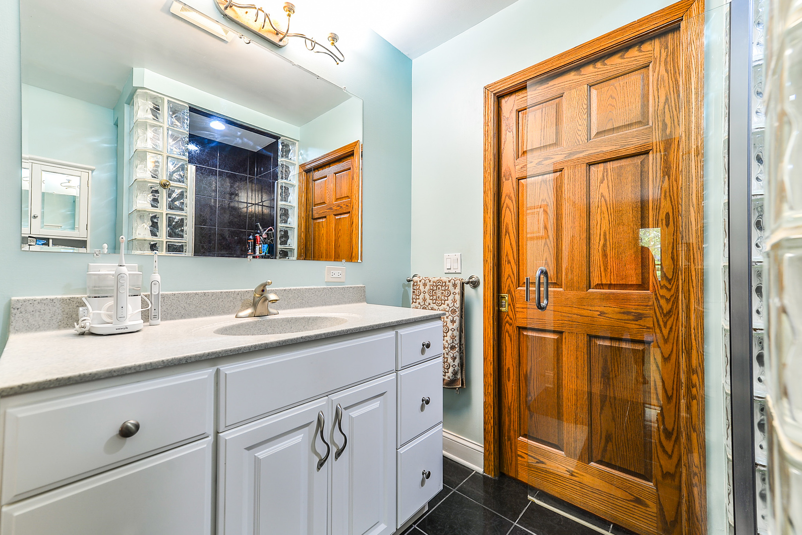 624 Riedy Road Lisle, IL 60532 - Photo 41 of 68 a bathroom with a granite countertop sink and a mirror