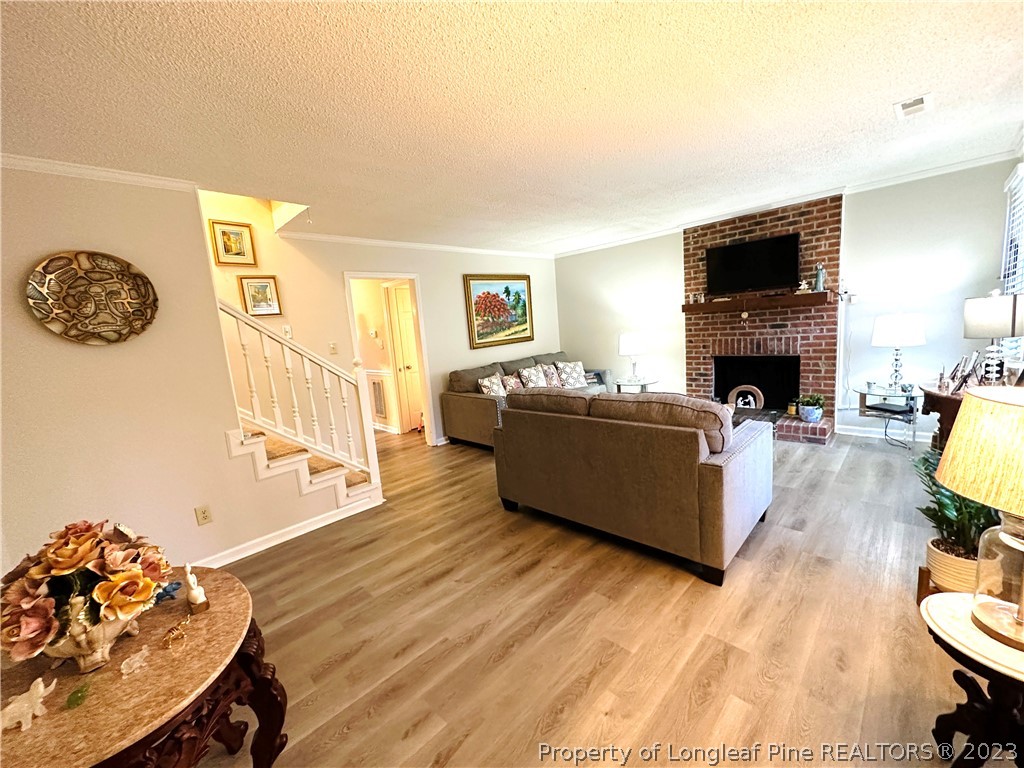 5635 Hamstead Crossing Raleigh, NC 27612 - Photo 3 of 18 a living room with furniture and a fireplace