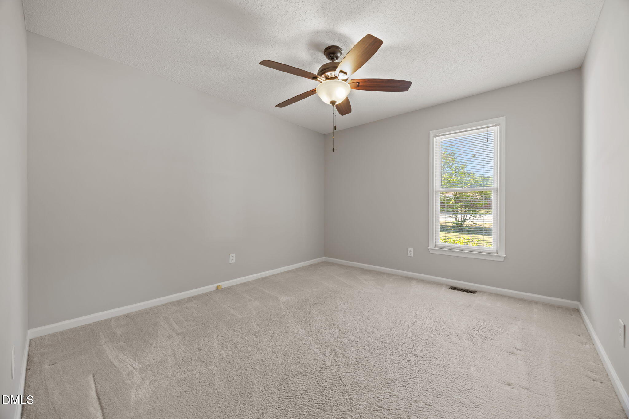 40 Circle Tree Lane Angier, NC 27501 - Photo 26 of 39 an empty room with a window and a fan