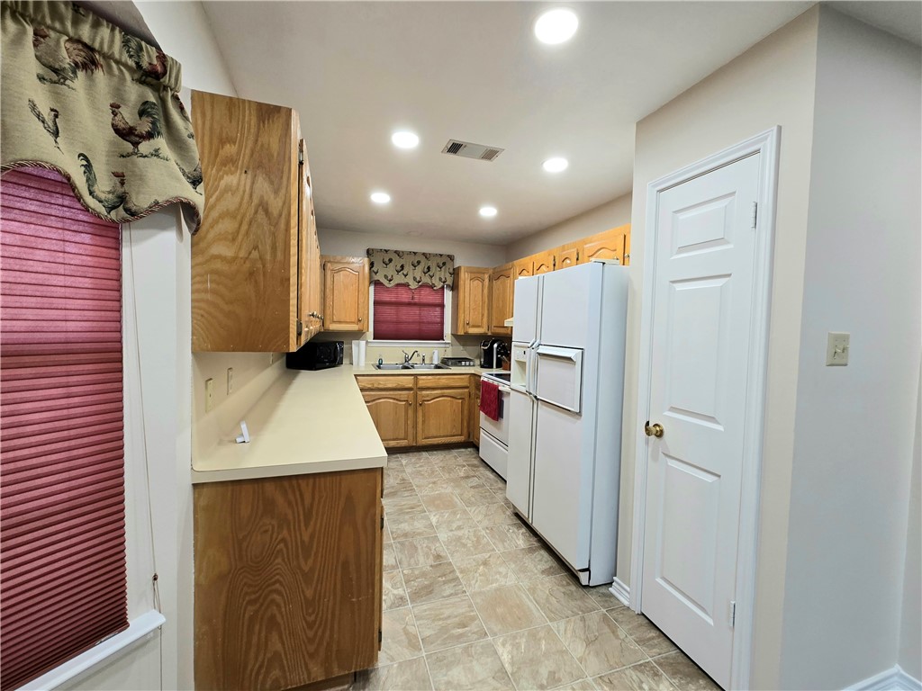 219 Ripple Creek Lane Somerville, TX 77879 - Photo 26 of 46 a kitchen with a sink a refrigerator and a stove