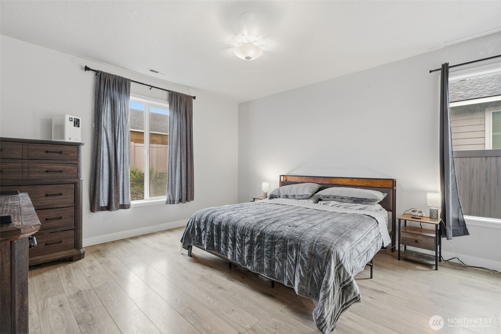 2572 Clark Ridge Drive Richland, WA 99352 - Photo 13 of 25 a bedroom with a bed and a flat tv screen on a dresser