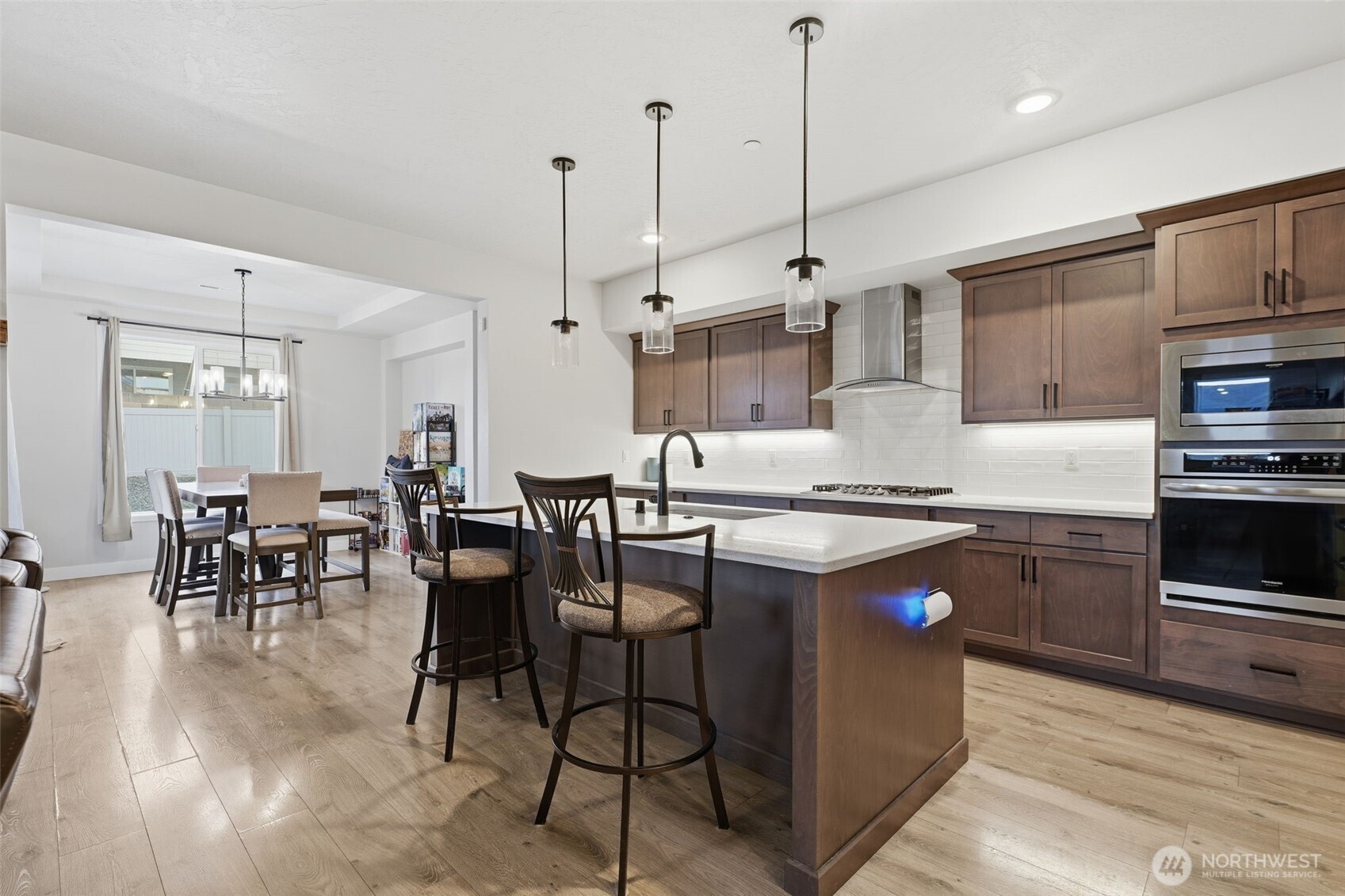 2572 Clark Ridge Drive Richland, WA 99352 - Photo 2 of 18 a kitchen with stainless steel appliances granite countertop a stove a sink a oven a dining table chairs and view kitchen