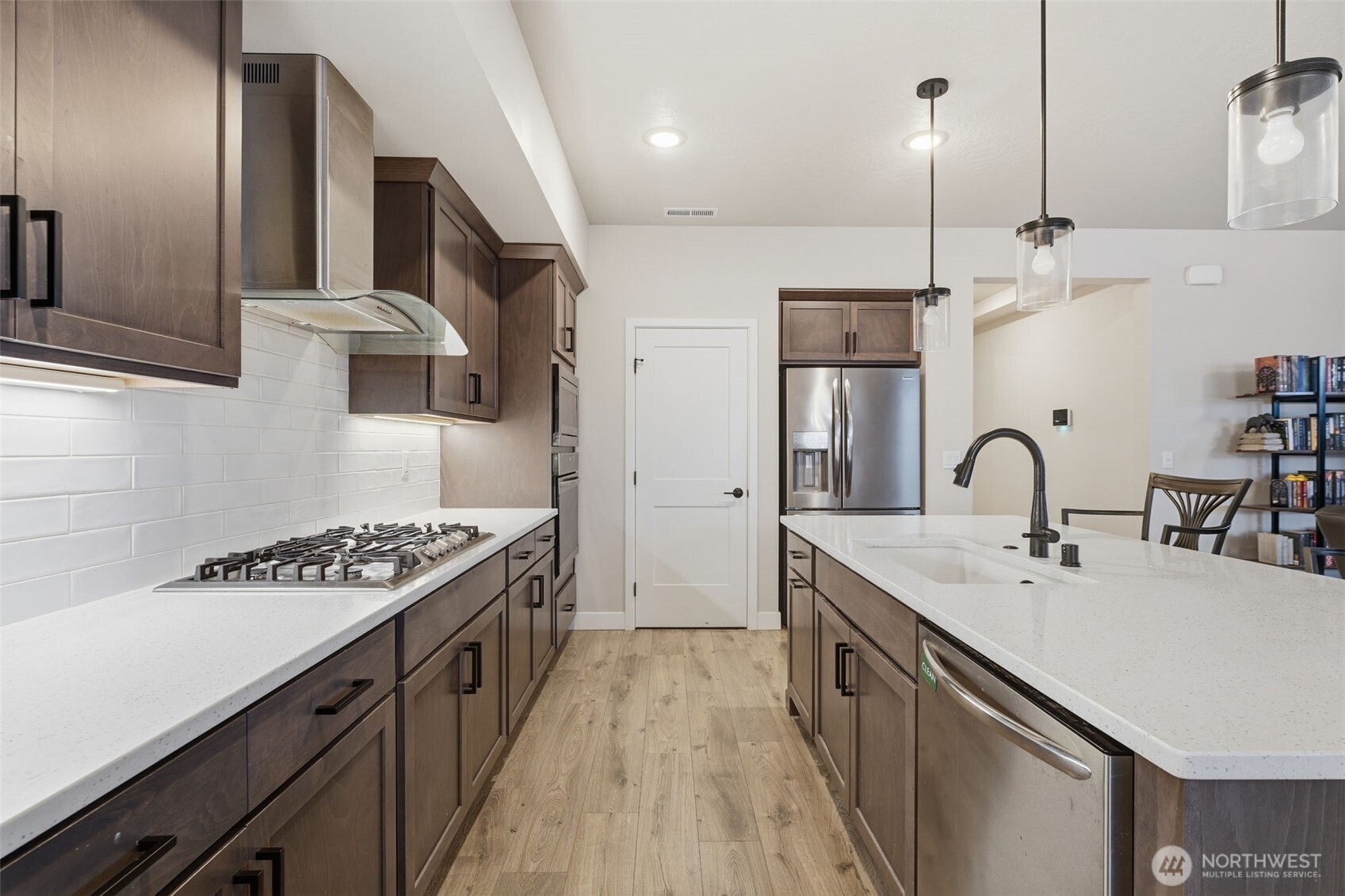 2572 Clark Ridge Drive Richland, WA 99352 - Photo 3 of 18 a kitchen with kitchen island stainless steel appliances a sink stove and cabinets