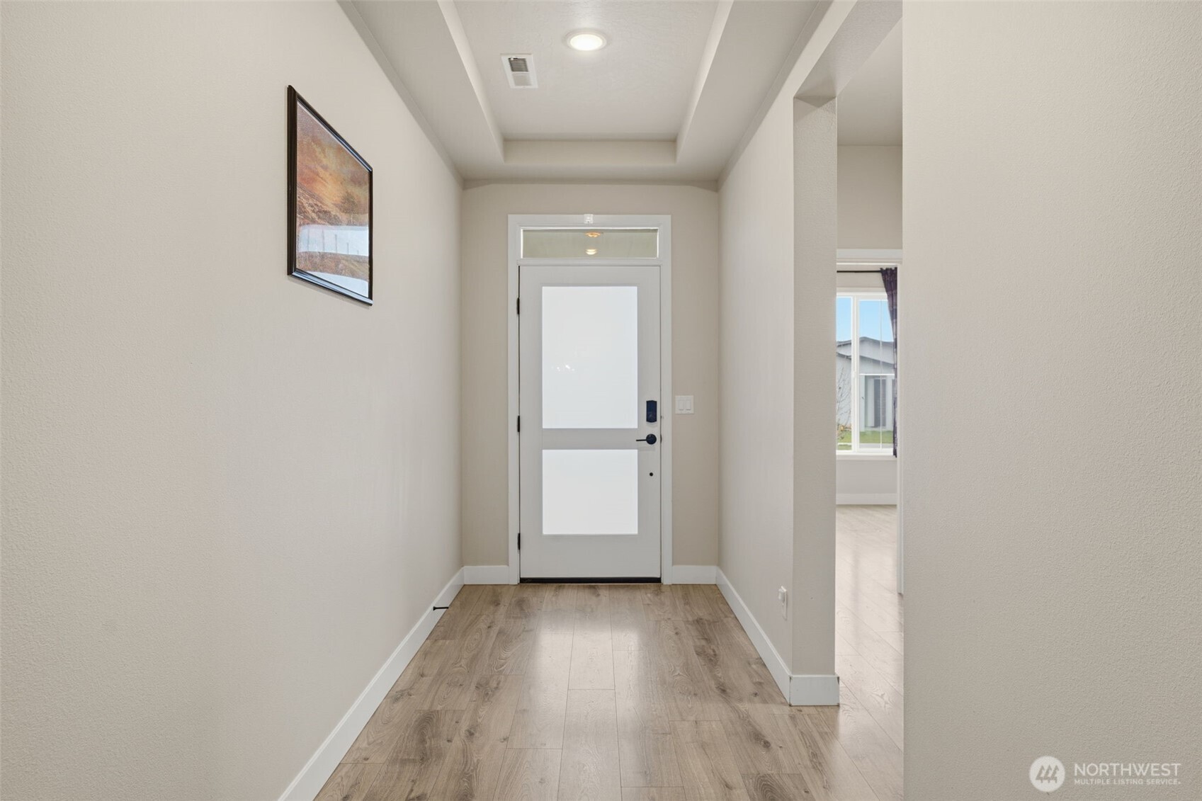 2572 Clark Ridge Drive Richland, WA 99352 - Photo 3 of 25 a view of a hallway with wooden floor and a bathroom