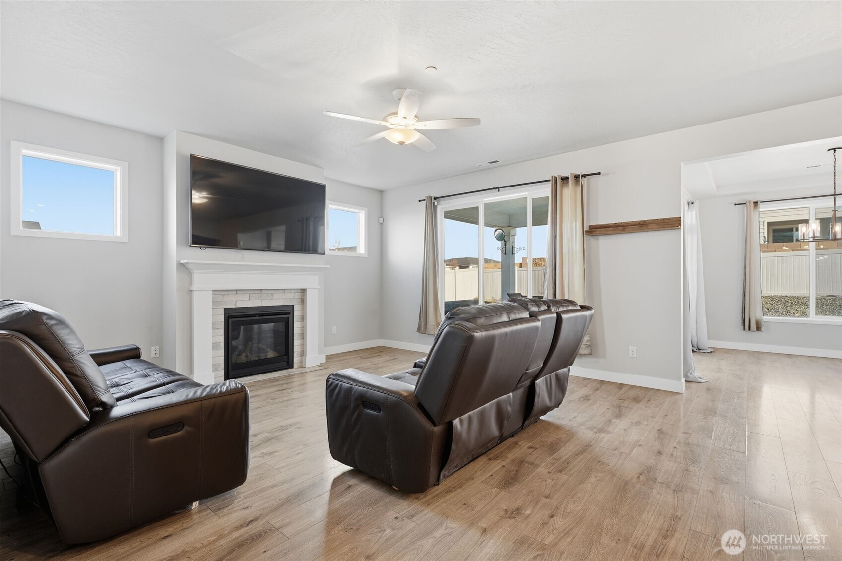2572 Clark Ridge Drive Richland, WA 99352 - Photo 4 of 25 a living room with furniture a flat screen tv and a fireplace