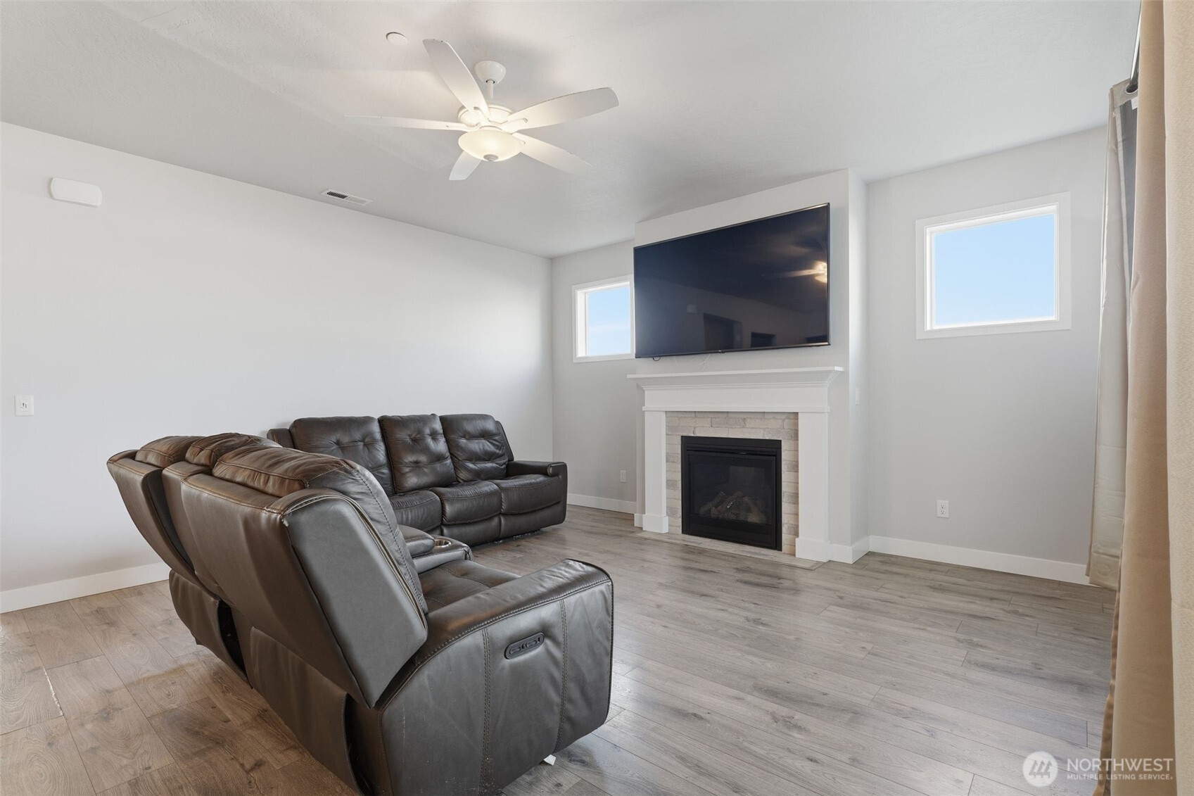 2572 Clark Ridge Drive Richland, WA 99352 - Photo 5 of 25 a living room with furniture a flat screen tv and a fireplace