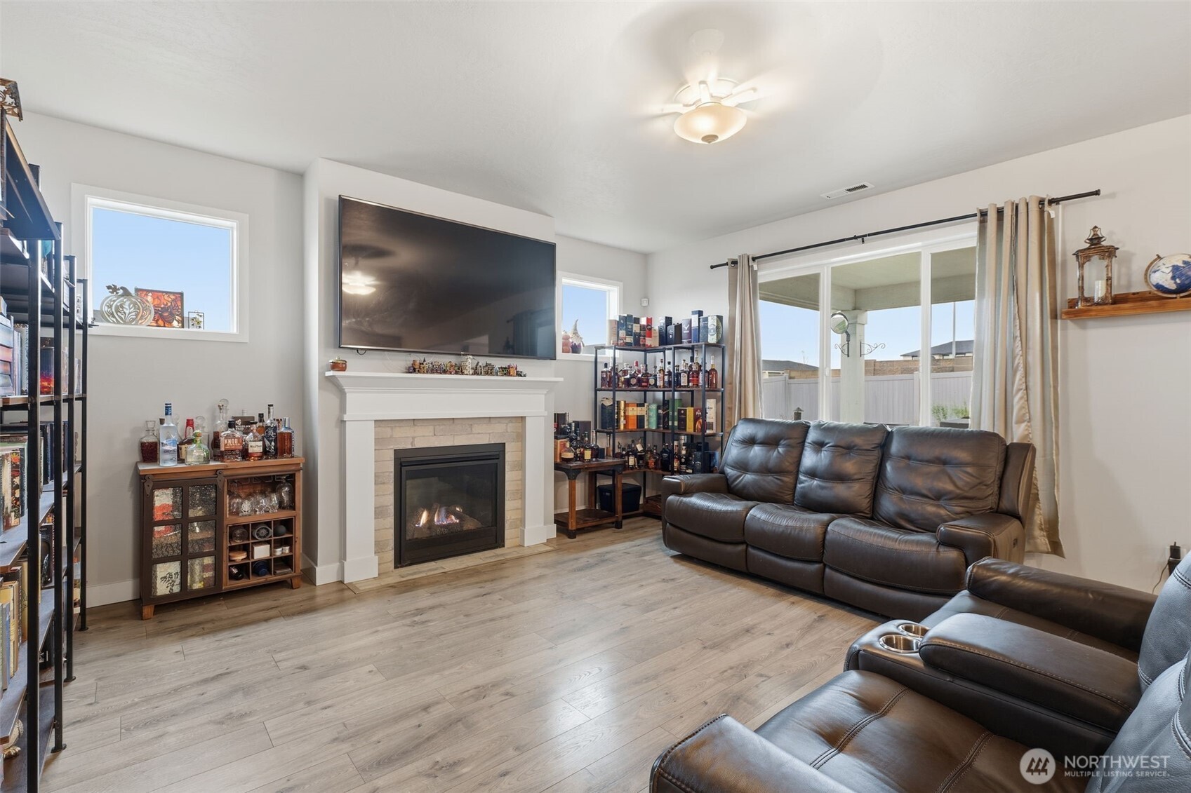 2572 Clark Ridge Drive Richland, WA 99352 - Photo 6 of 18 a living room with furniture a flat screen tv and a fireplace