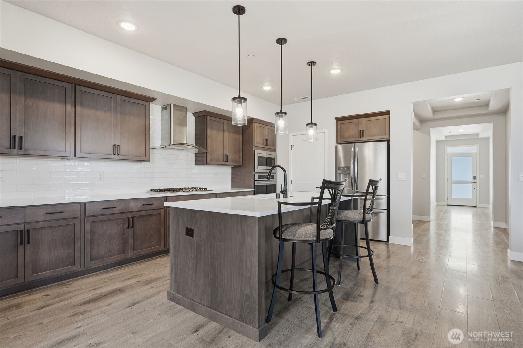 2572 Clark Ridge Drive Richland, WA 99352 - Photo 8 of 25 a kitchen with stainless steel appliances granite countertop a table chairs sink and cabinets