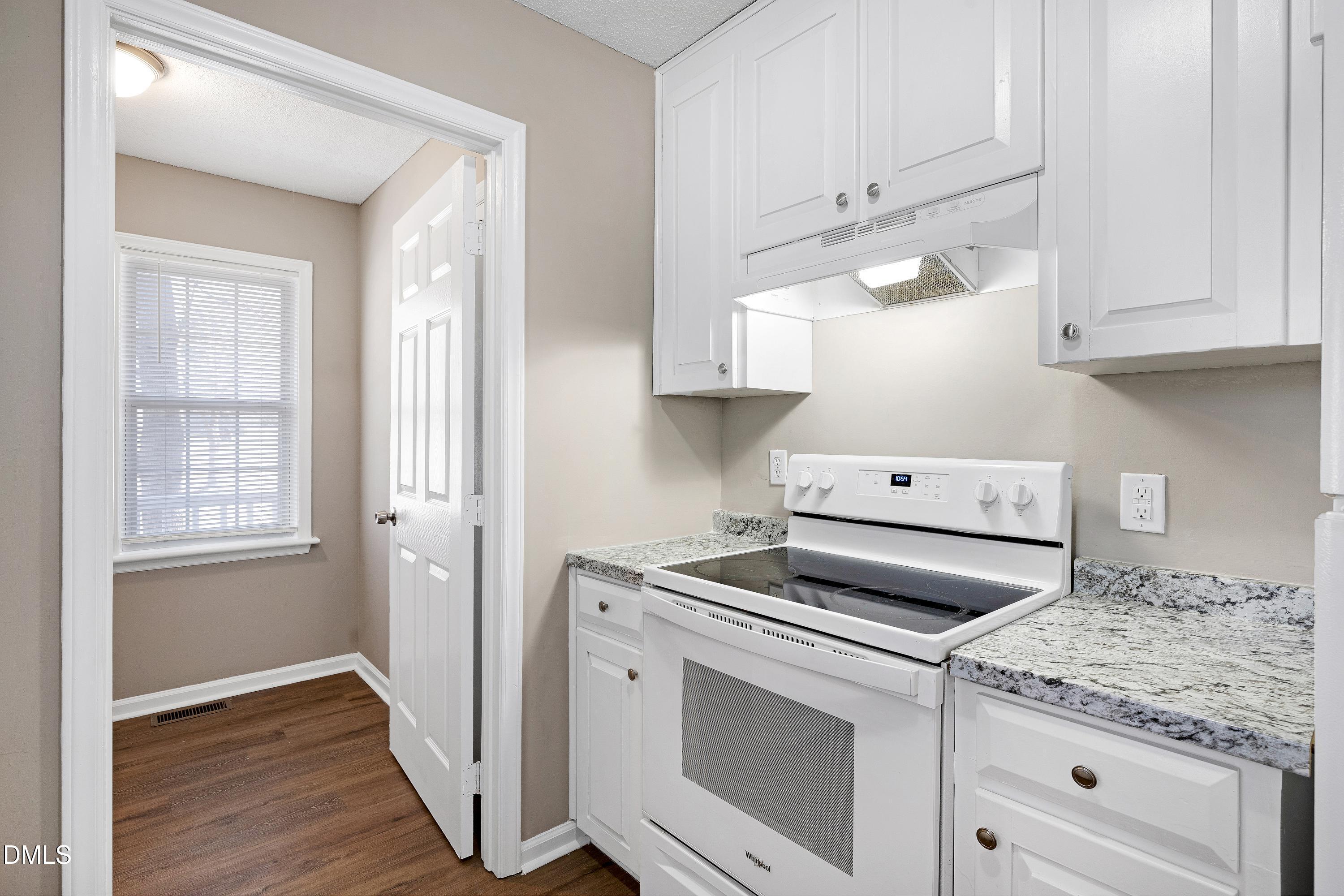 4100 Rockside Hills Drive Raleigh, NC 27603 - Photo 14 of 52 a kitchen with cabinets appliances and wooden floor