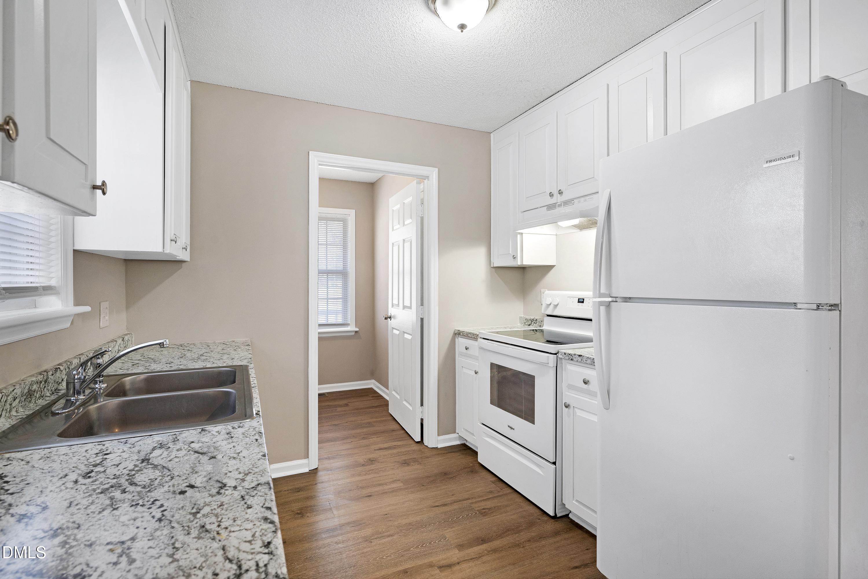 4100 Rockside Hills Drive Raleigh, NC 27603 - Photo 15 of 52 a kitchen with a refrigerator stove and sink
