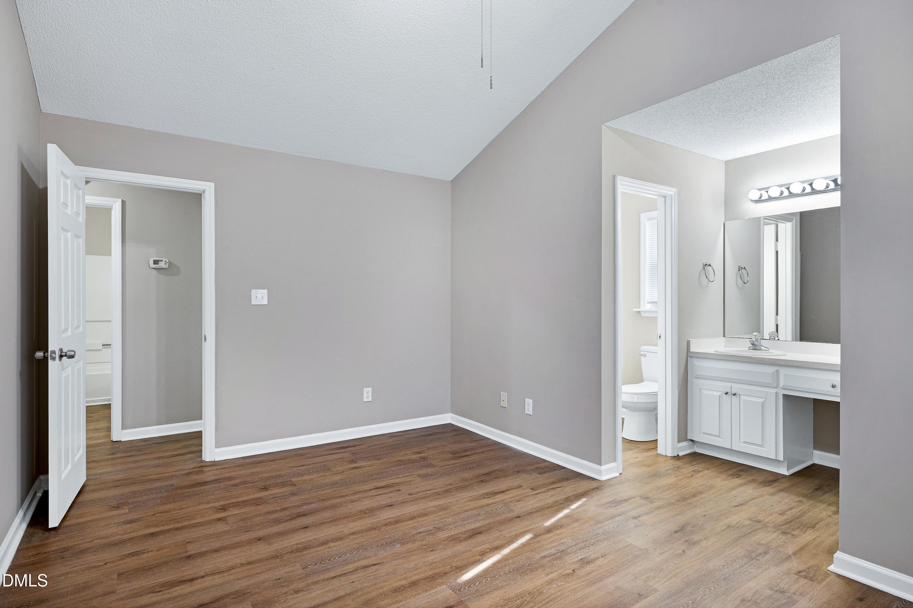 4100 Rockside Hills Drive Raleigh, NC 27603 - Photo 21 of 52 an empty room with wooden floor and cabinet