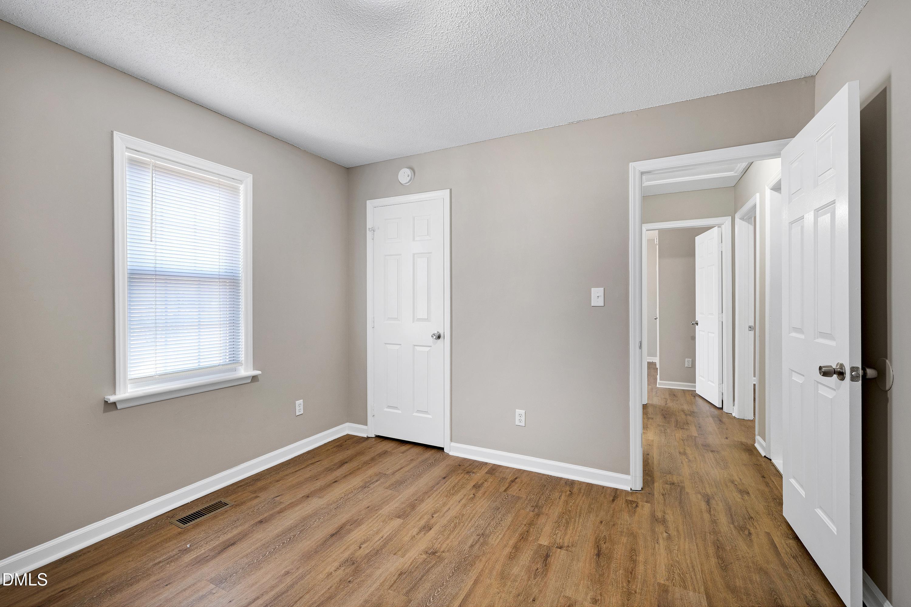 4100 Rockside Hills Drive Raleigh, NC 27603 - Photo 25 of 52 a view of an empty room with wooden floor and a window