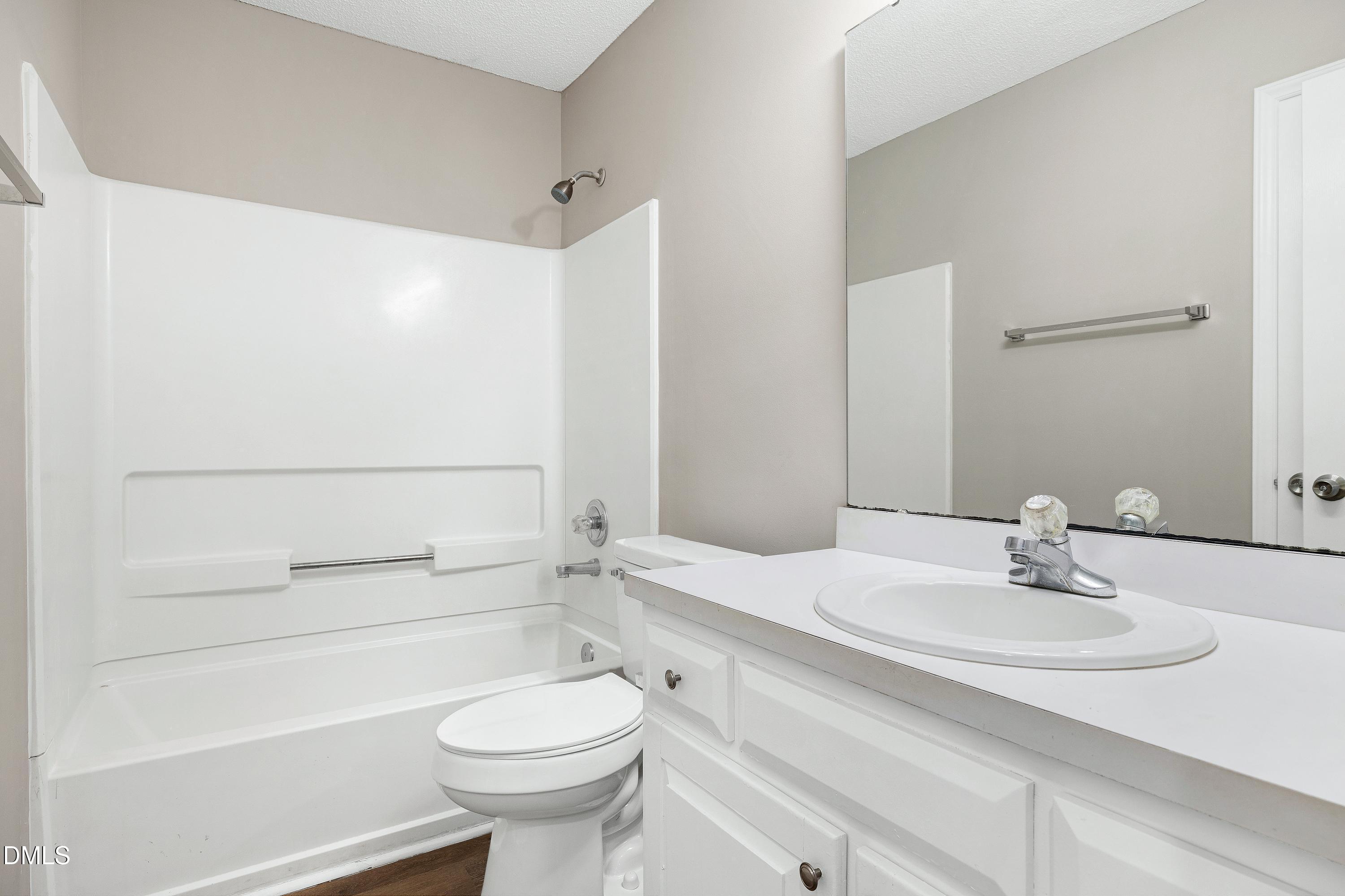 4100 Rockside Hills Drive Raleigh, NC 27603 - Photo 28 of 52 a bathroom with a sink a toilet and shower