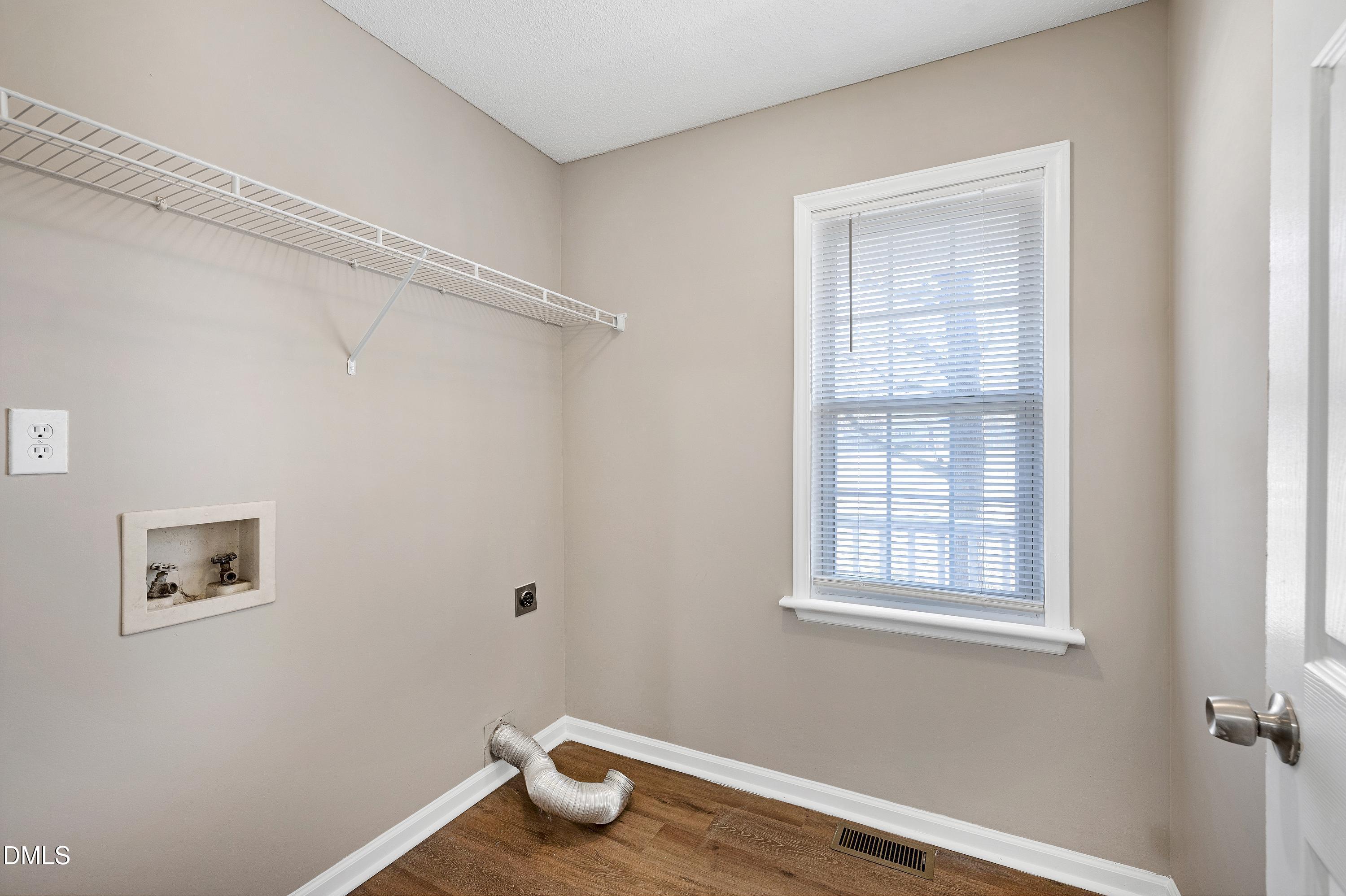 4100 Rockside Hills Drive Raleigh, NC 27603 - Photo 29 of 52 a view of an empty room with wooden floor and a window