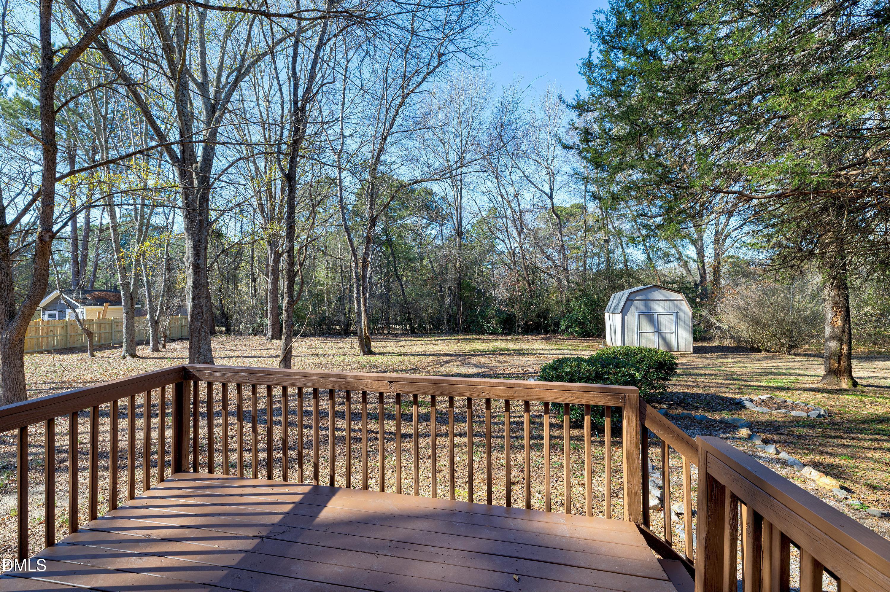 4100 Rockside Hills Drive Raleigh, NC 27603 - Photo 43 of 52 a view of a roof deck with two couches and wooden floor next to a yard