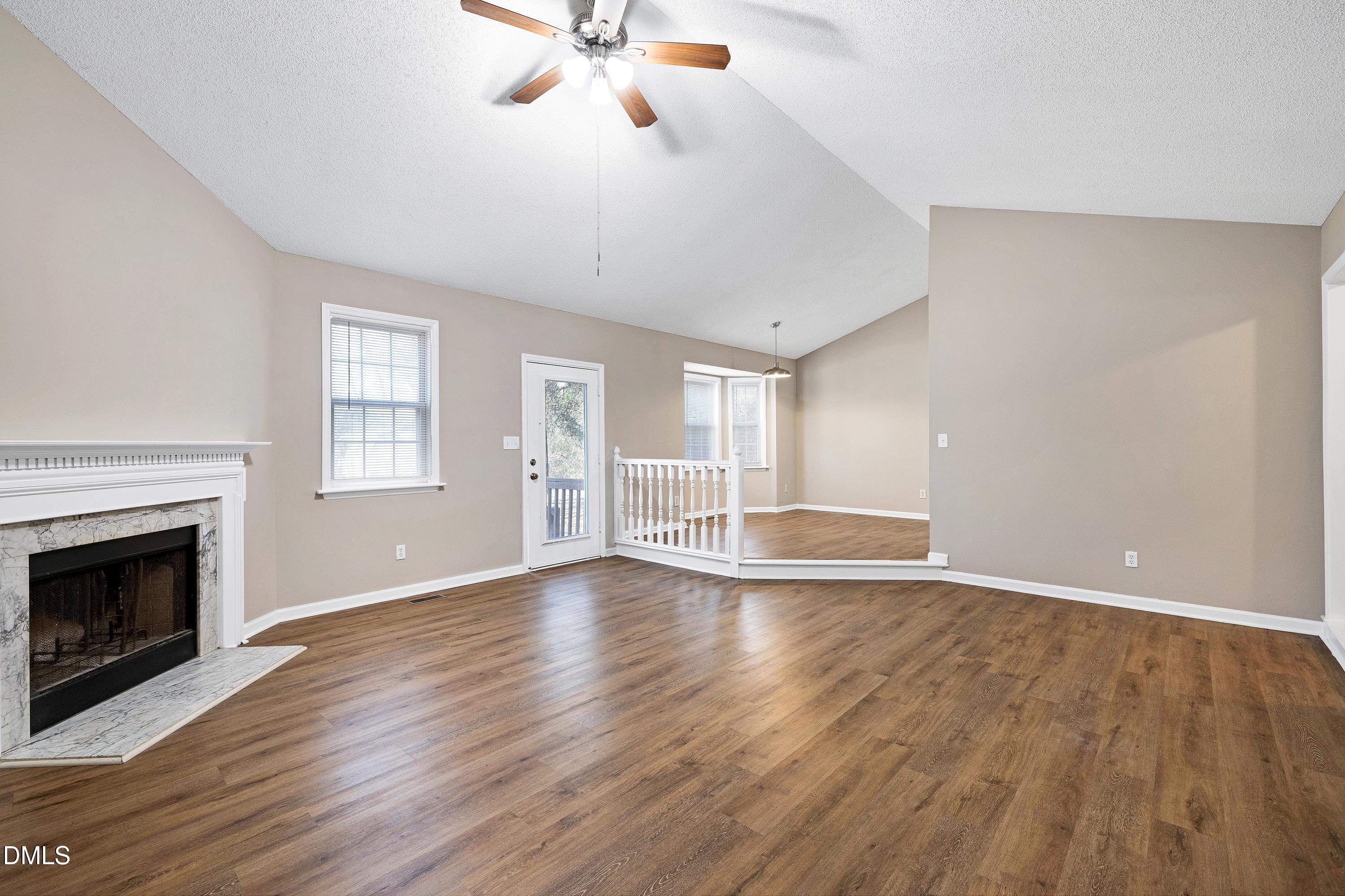 4100 Rockside Hills Drive Raleigh, NC 27603 - Photo 5 of 52 a view of an empty room with wooden floor and a window