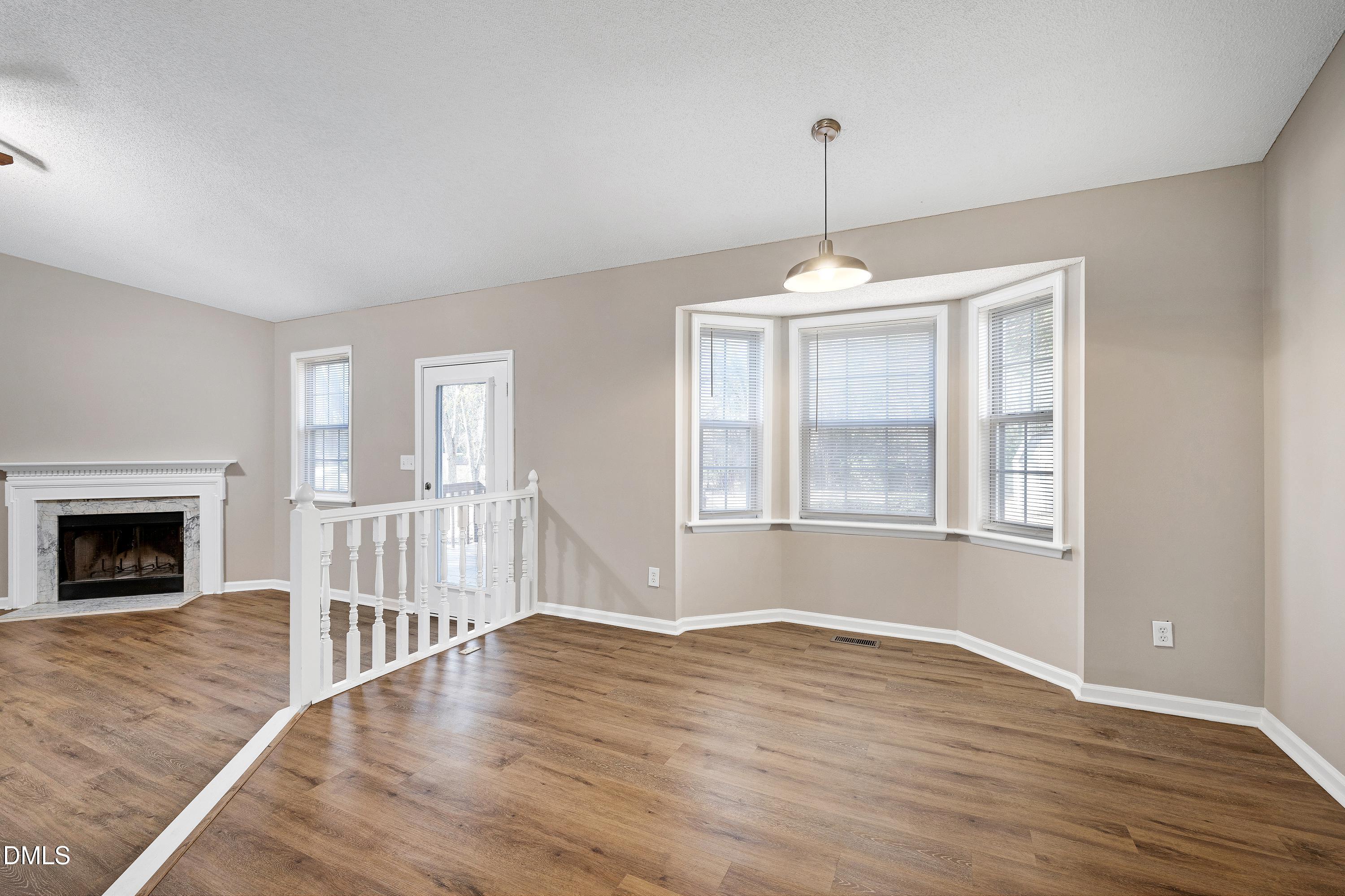 4100 Rockside Hills Drive Raleigh, NC 27603 - Photo 6 of 52 a view of wooden floor fireplace and windows in an empty room