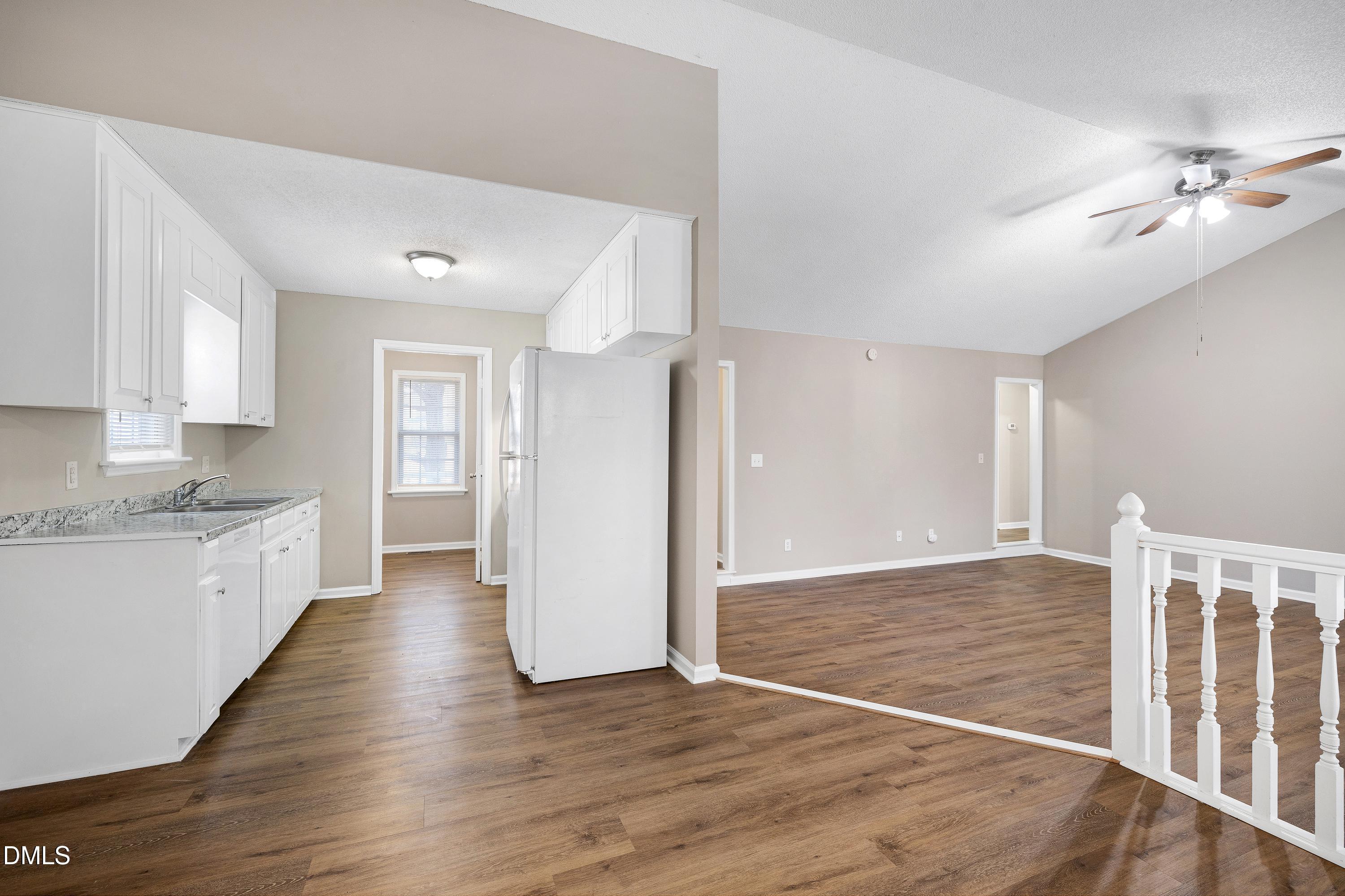 4100 Rockside Hills Drive Raleigh, NC 27603 - Photo 7 of 52 a view of an empty room with window and wooden floor