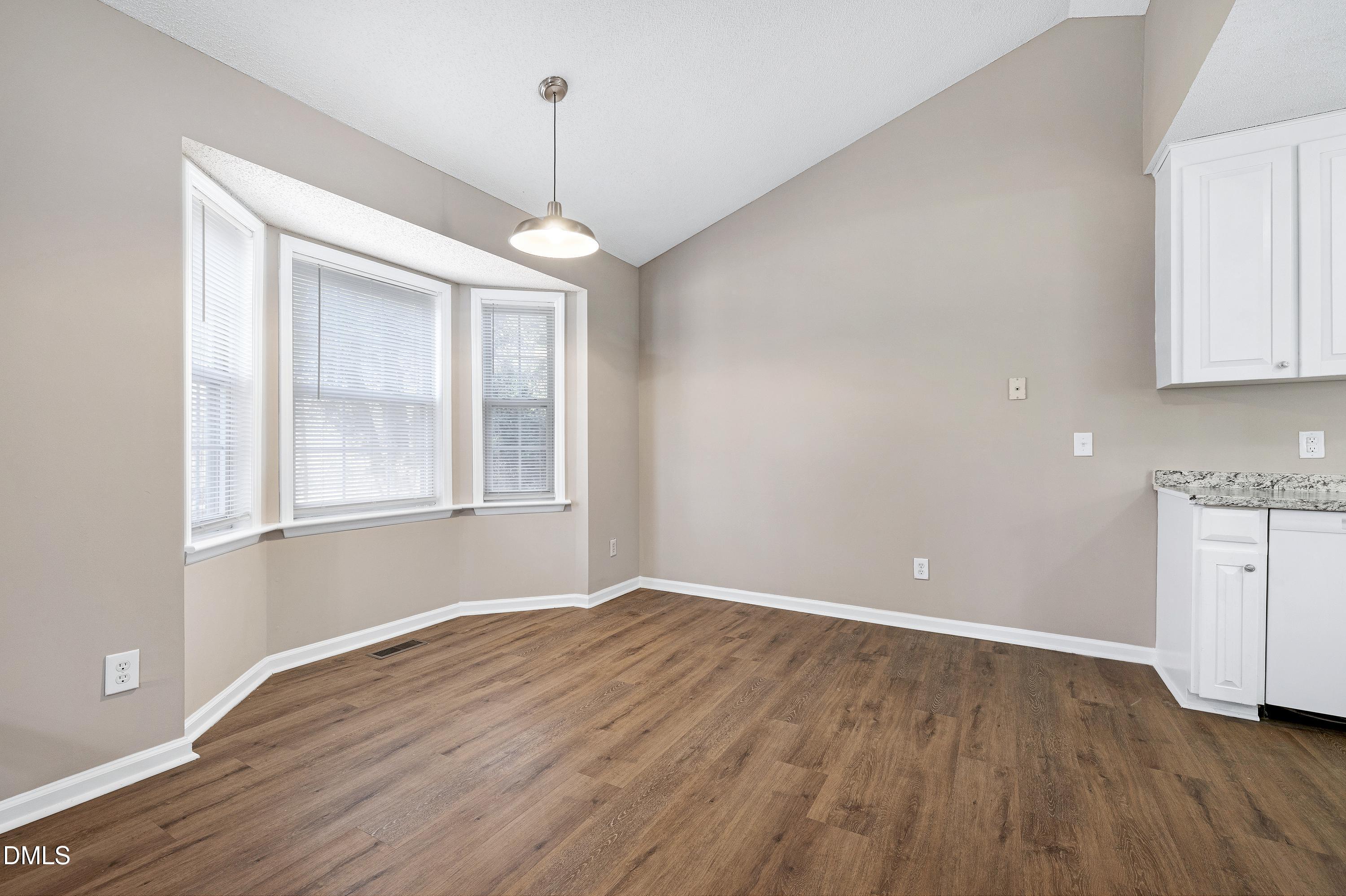 4100 Rockside Hills Drive Raleigh, NC 27603 - Photo 9 of 52 a view of empty room with wooden floor and window
