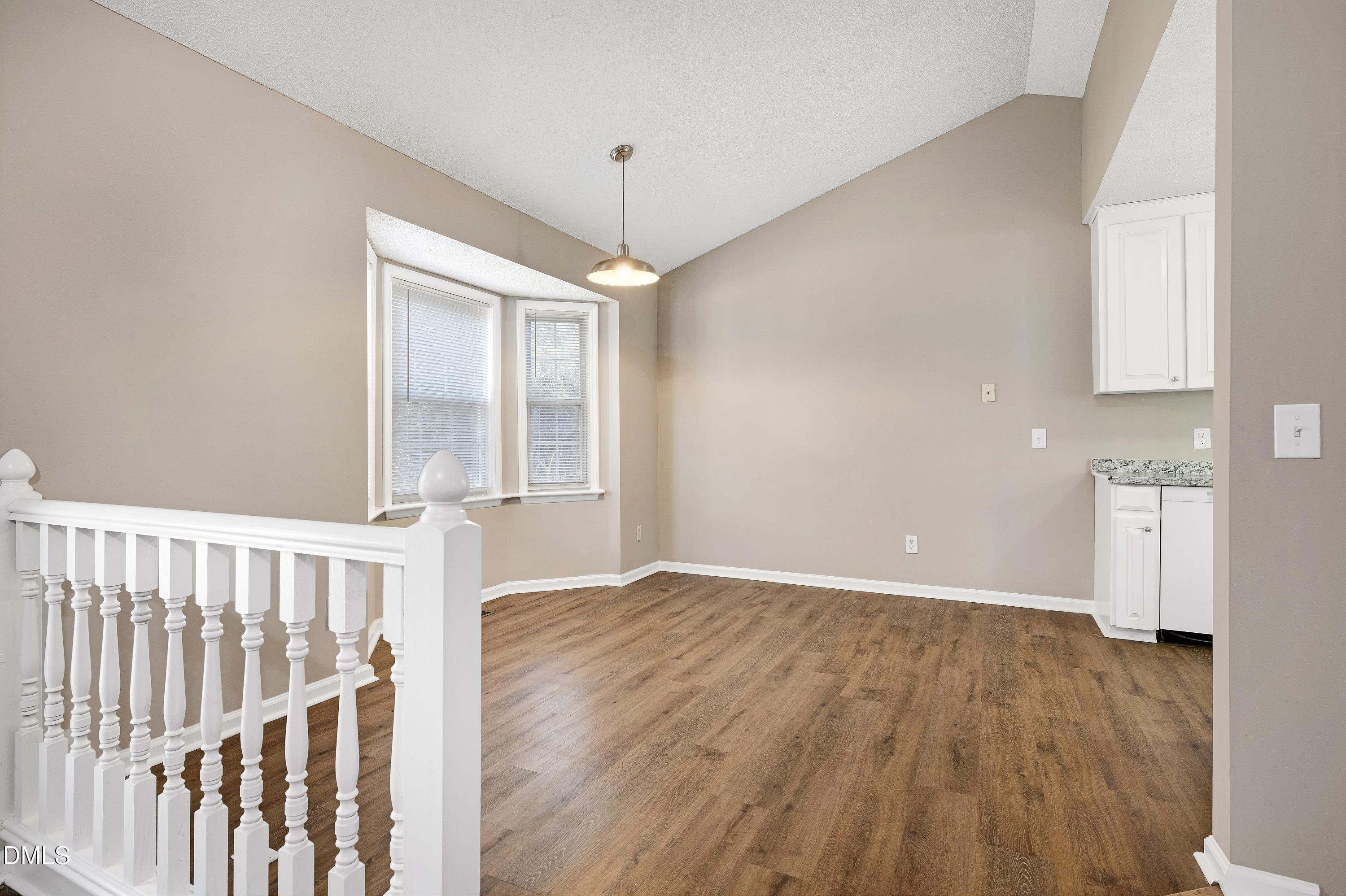 4100 Rockside Hills Drive Raleigh, NC 27603 - Photo 10 of 52 a view of an empty room with a window and wooden floor