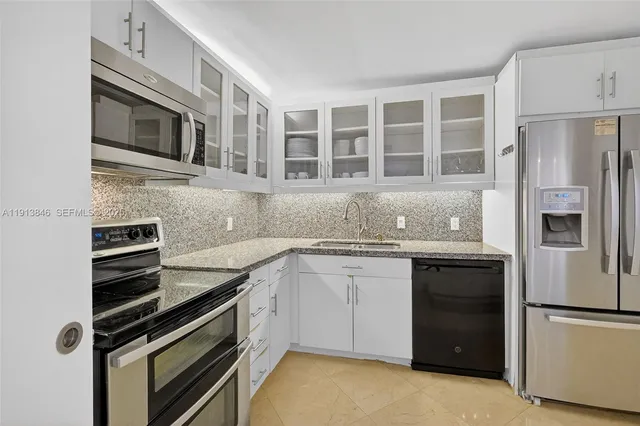 a kitchen with a sink stove and refrigerator