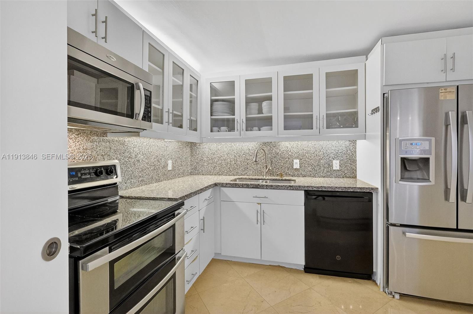 2 Grove Isle Drive, Unit B1505 Miami, FL 33133 - Photo 11 of 51 a kitchen with a sink stove and refrigerator