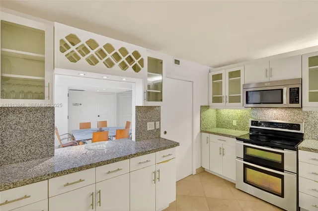 a kitchen with stainless steel appliances a sink and a microwave