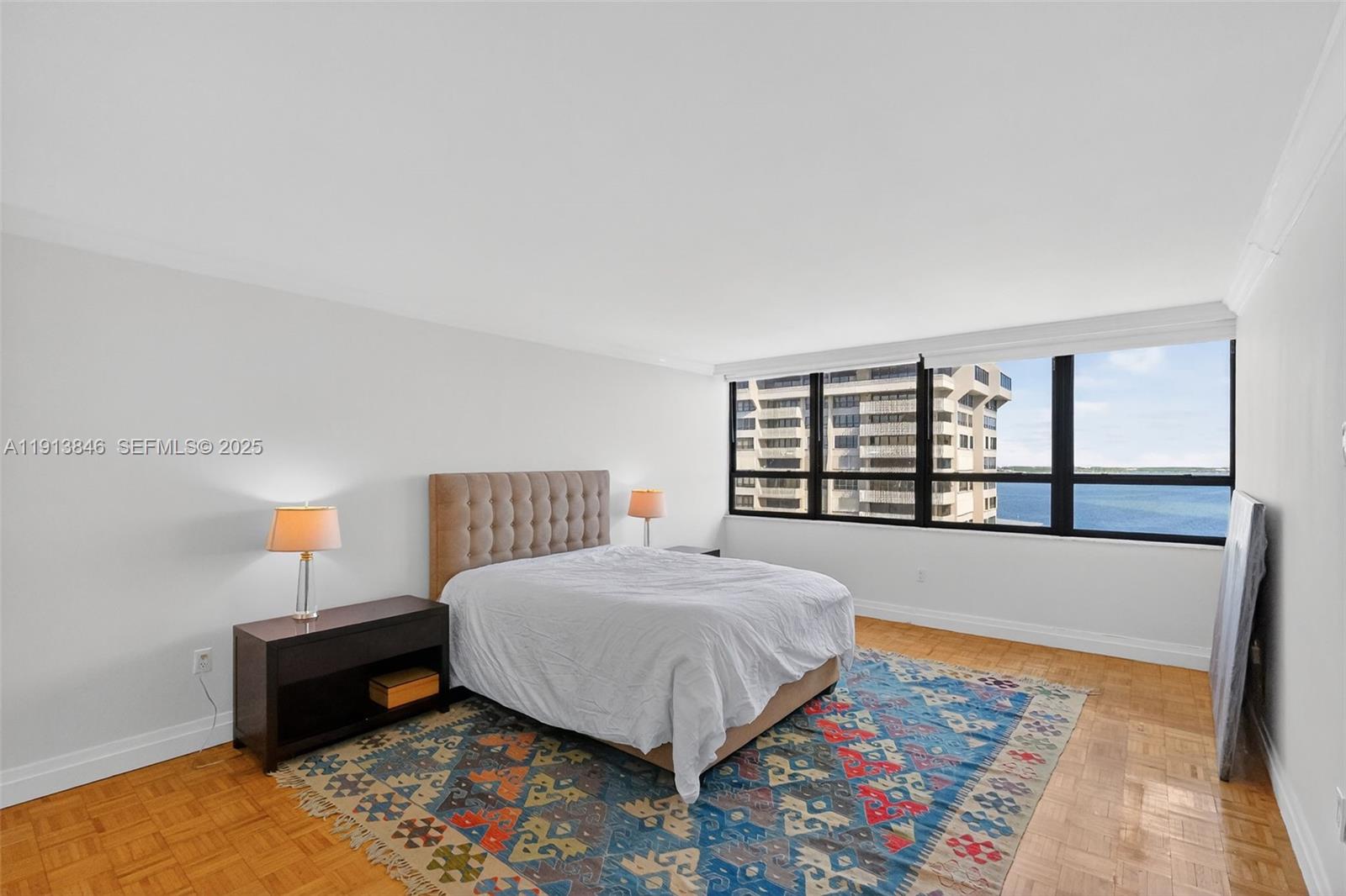 2 Grove Isle Drive, Unit B1505 Miami, FL 33133 - Photo 19 of 51 a bed sitting in a bedroom next to a window