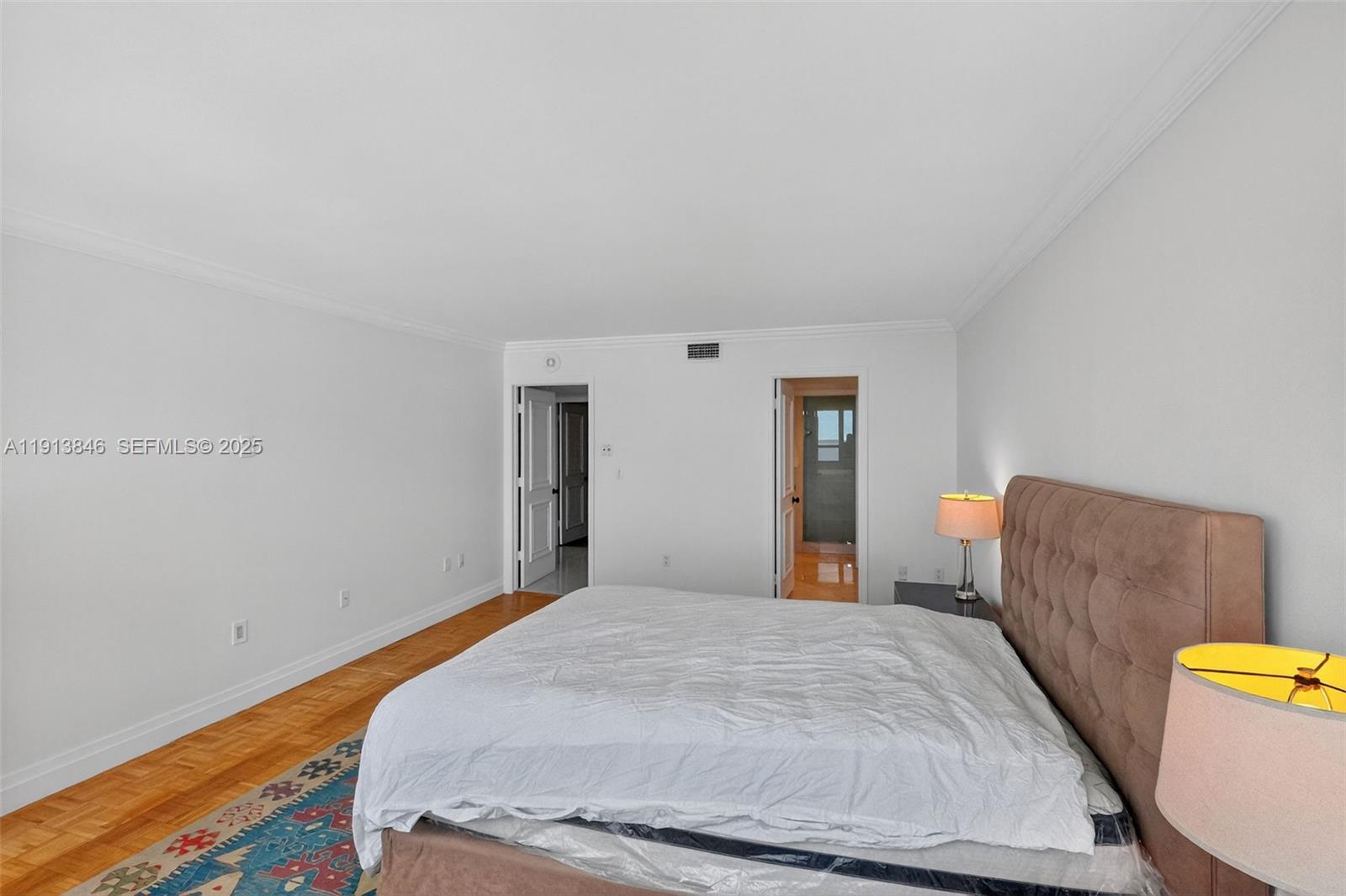 2 Grove Isle Drive, Unit B1505 Miami, FL 33133 - Photo 21 of 51 a bedroom with a bed and a couch