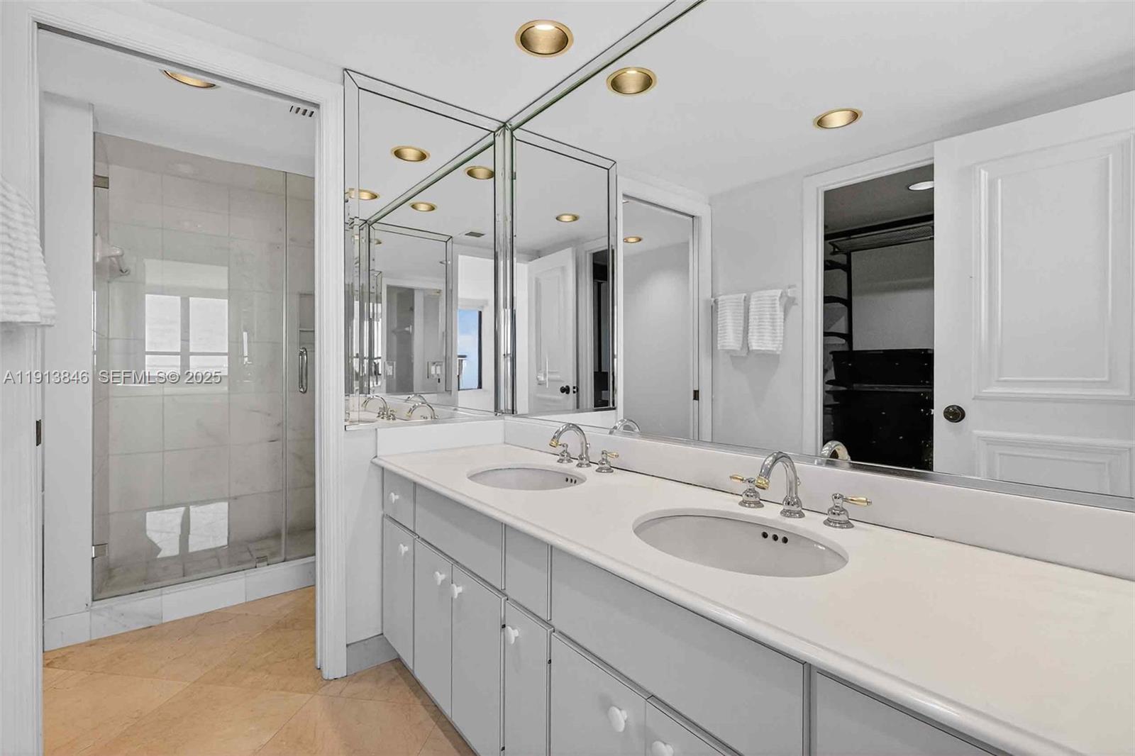 2 Grove Isle Drive, Unit B1505 Miami, FL 33133 - Photo 22 of 51 a bathroom with a sink double vanity and a mirror