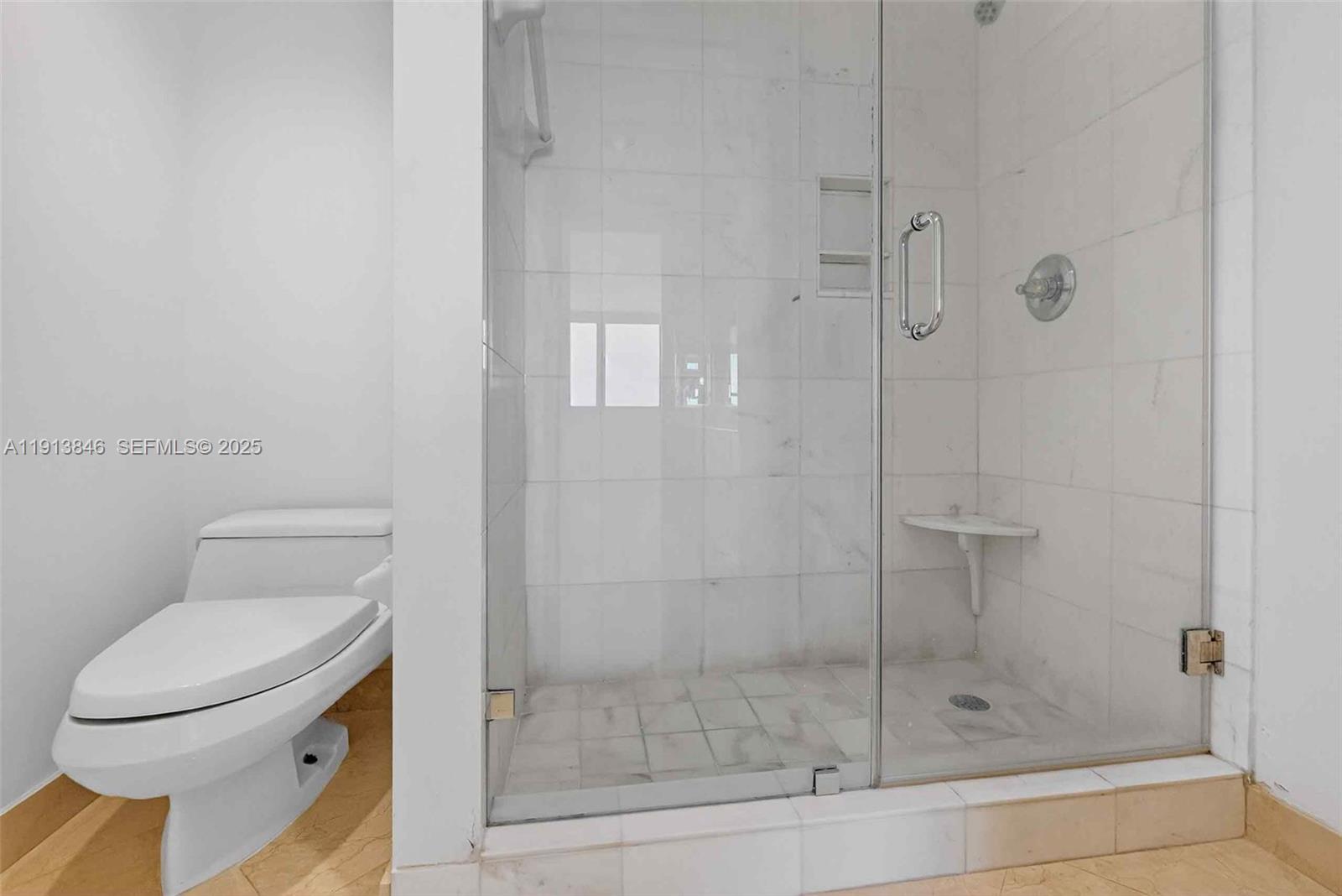 2 Grove Isle Drive, Unit B1505 Miami, FL 33133 - Photo 23 of 51 a bathroom with a shower and toilet