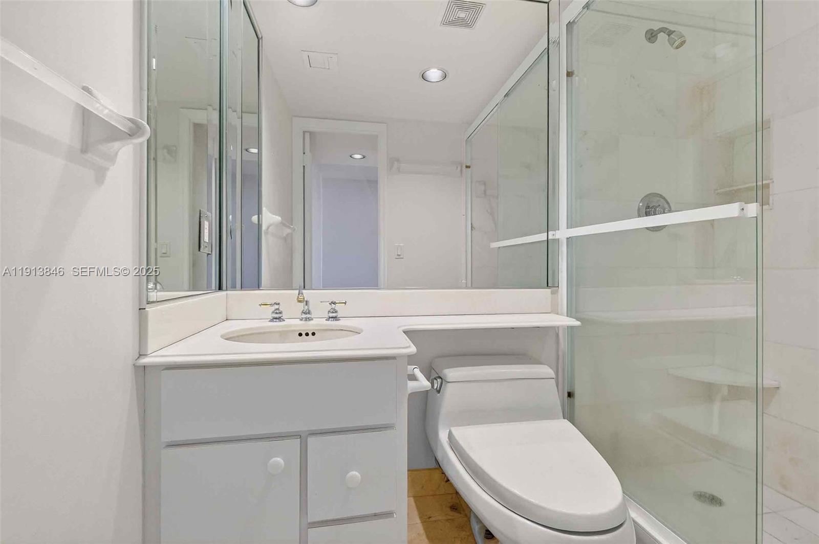 2 Grove Isle Drive, Unit B1505 Miami, FL 33133 - Photo 26 of 51 a bathroom with a toilet a sink and shower