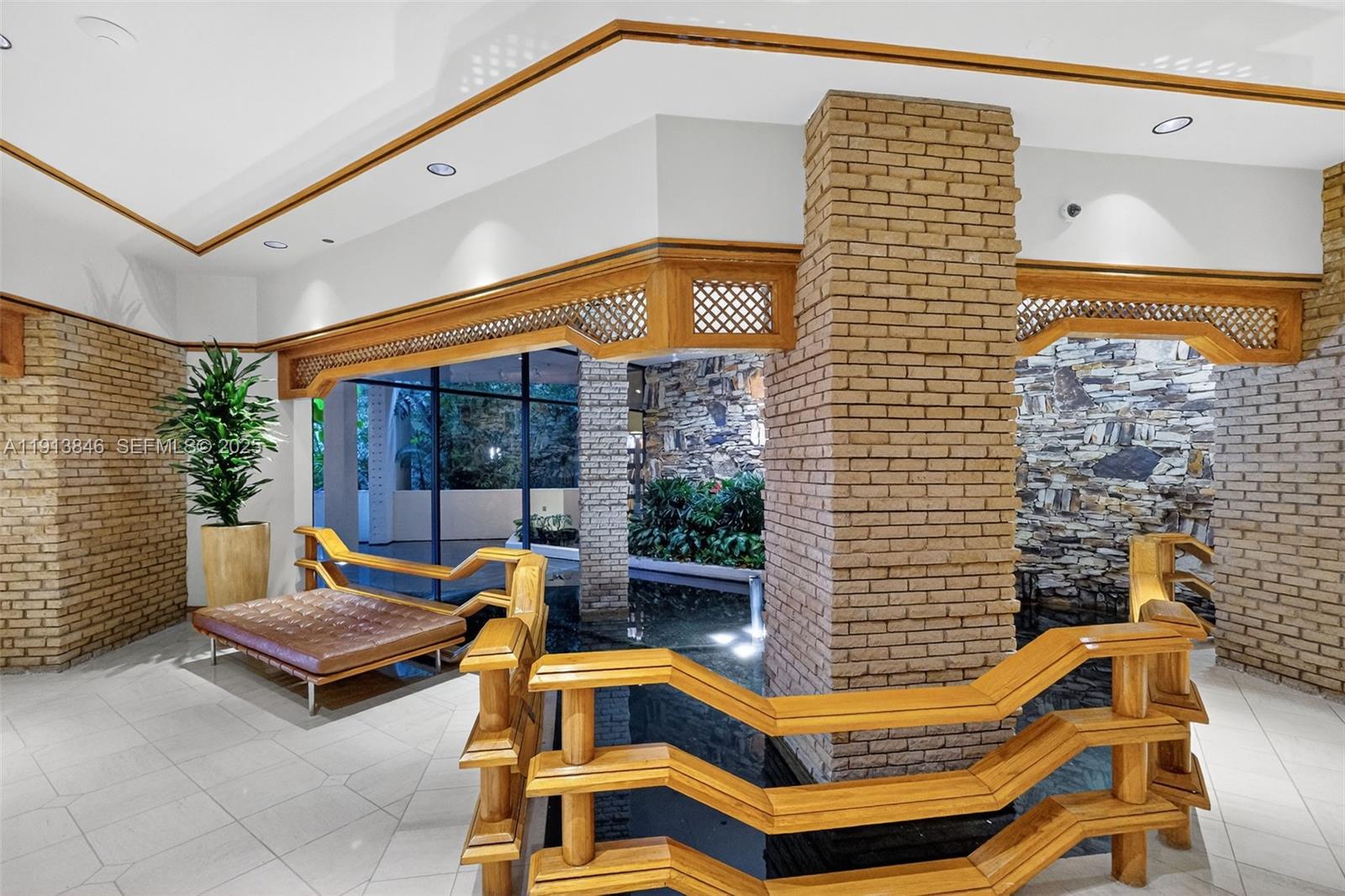 2 Grove Isle Drive, Unit B1505 Miami, FL 33133 - Photo 43 of 51 a patio with a table and chairs