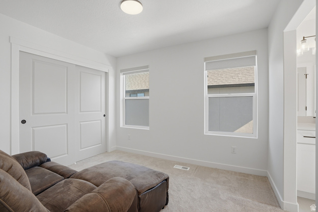 11531 Engelmann Drive Draper, UT 84020 - Photo 20 of 31 Bright interior space featuring light-colored carpeting, white walls, and a ceiling-mounted light fixture