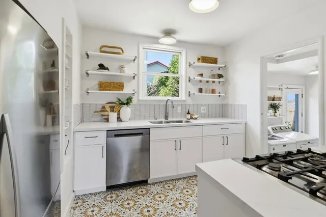 a kitchen with stove and cabinets