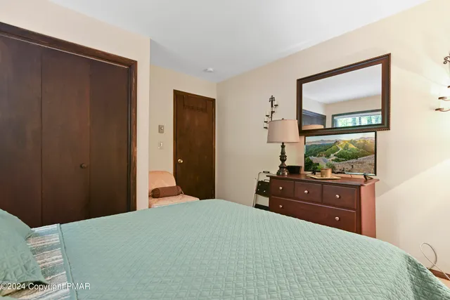 a bedroom with a bed and a dresser