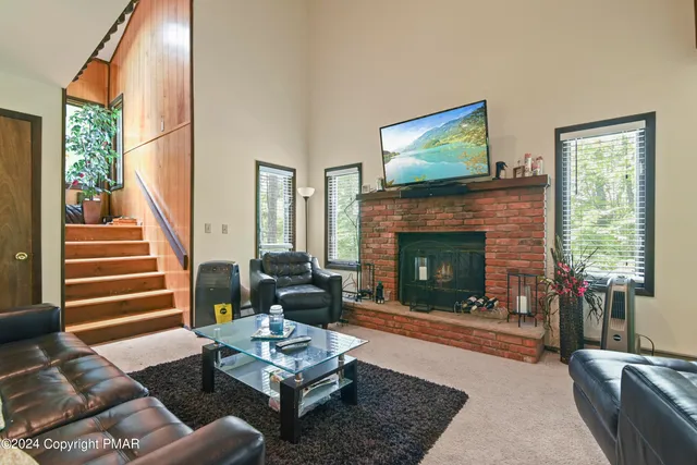a living room with furniture fireplace and window